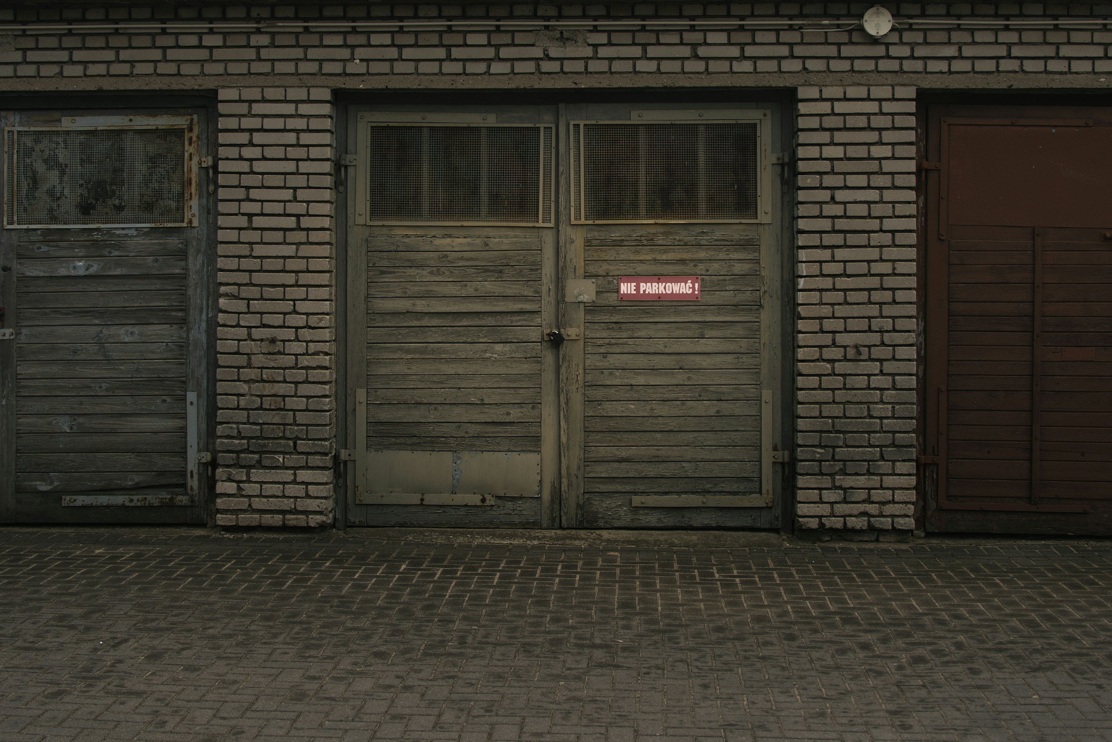 a garage door that is visibly crooked and off-track