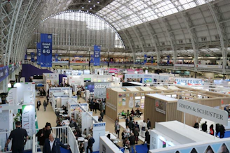 Busy exhibition hall with many booths and attendees