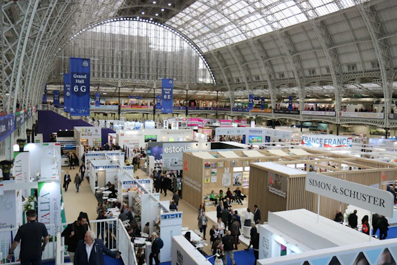 Busy exhibition hall with many booths and attendees