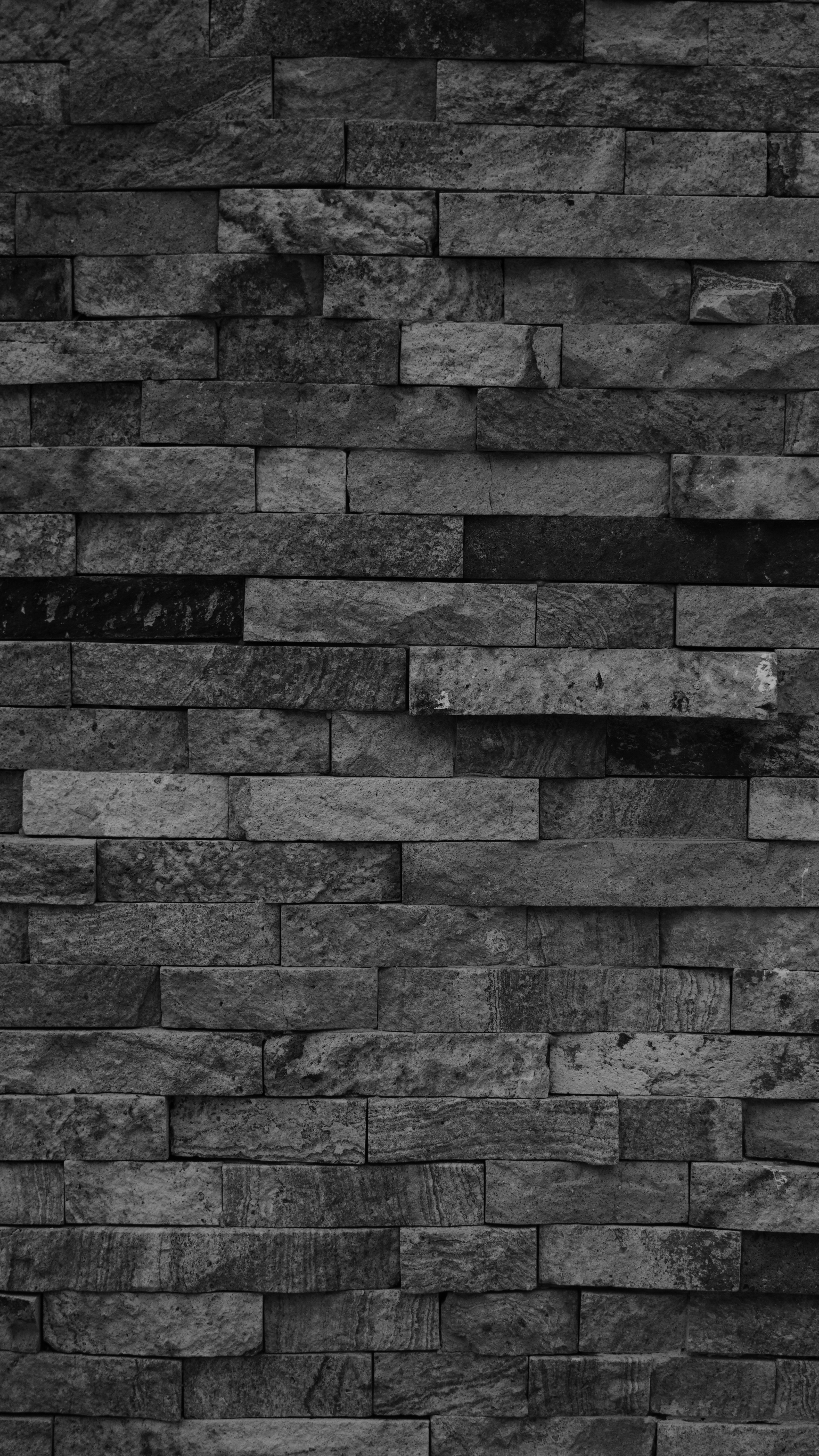 Stacked stone wall with varied gray tones.