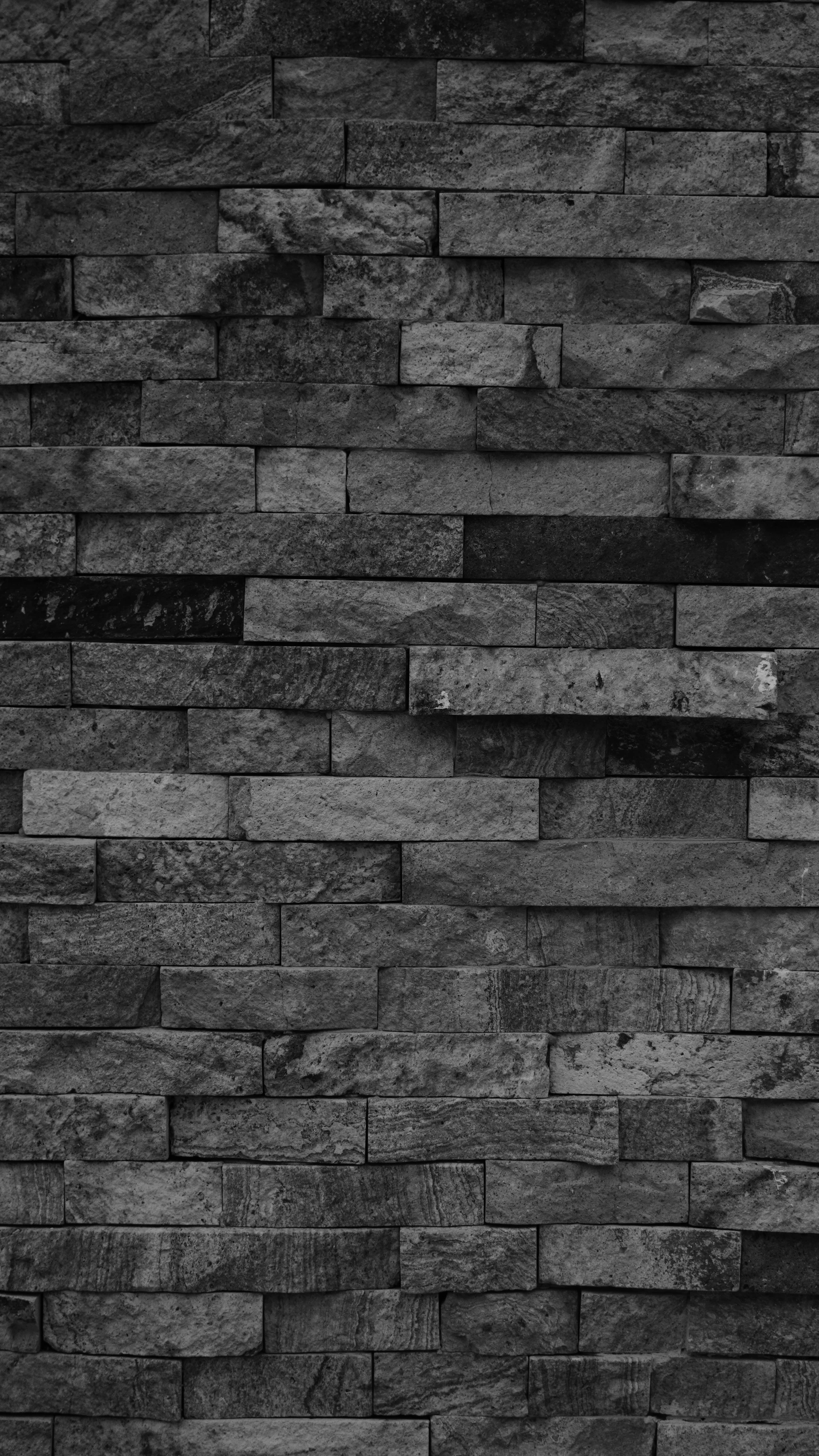 Stacked stone wall with varied gray tones.