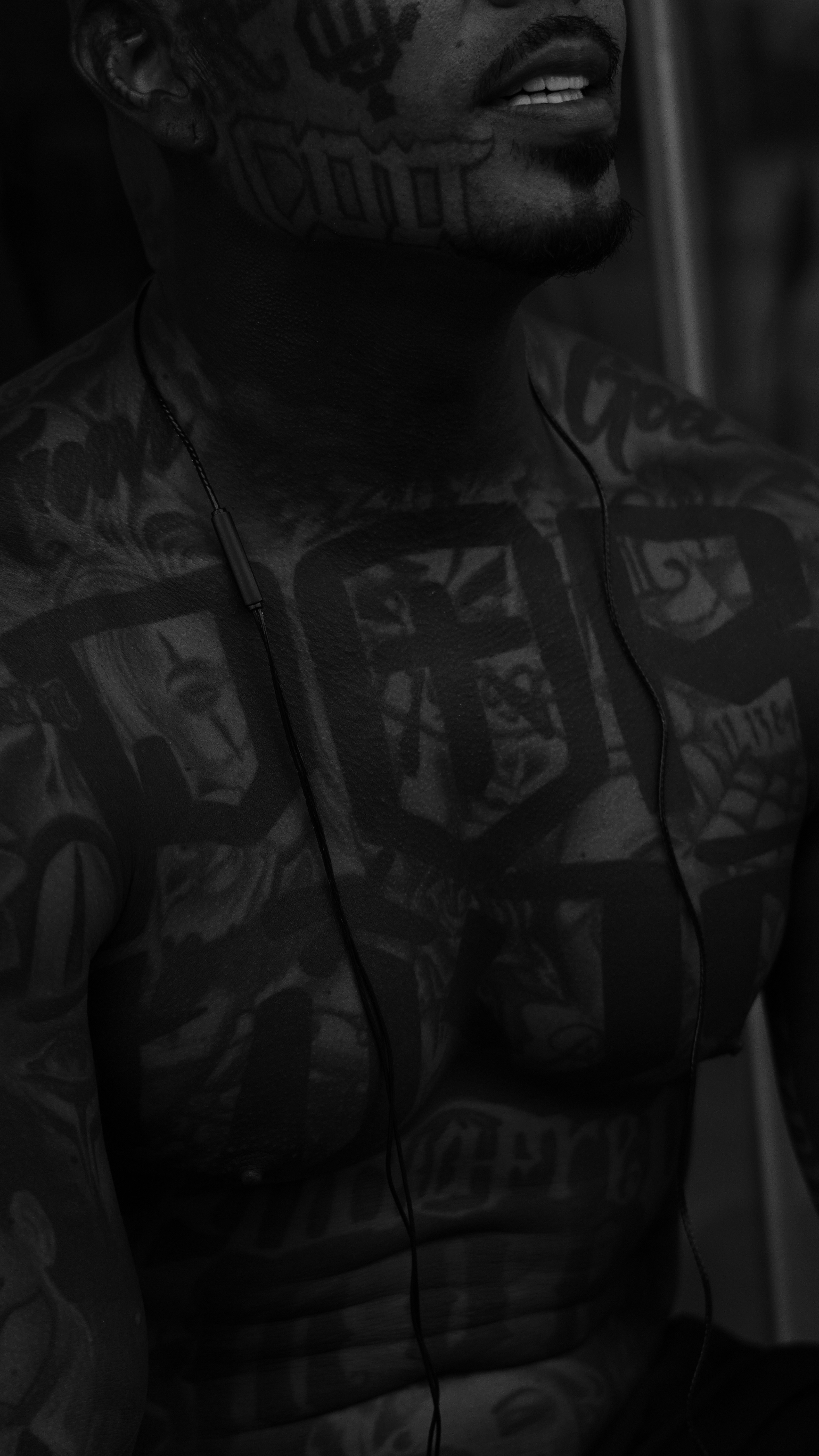 Man with extensive tattoos on face and chest