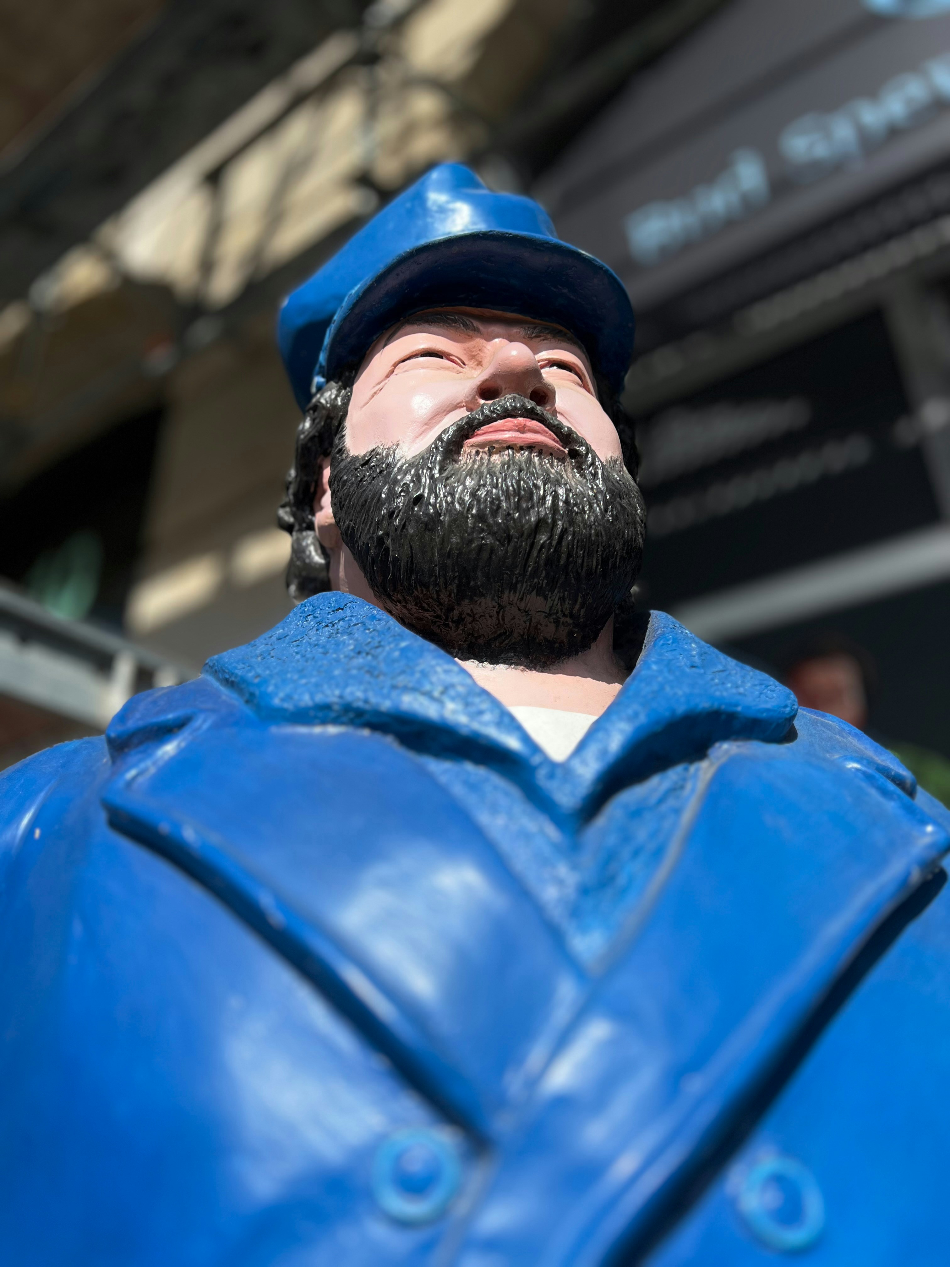 A blue statue of a man with a beard.