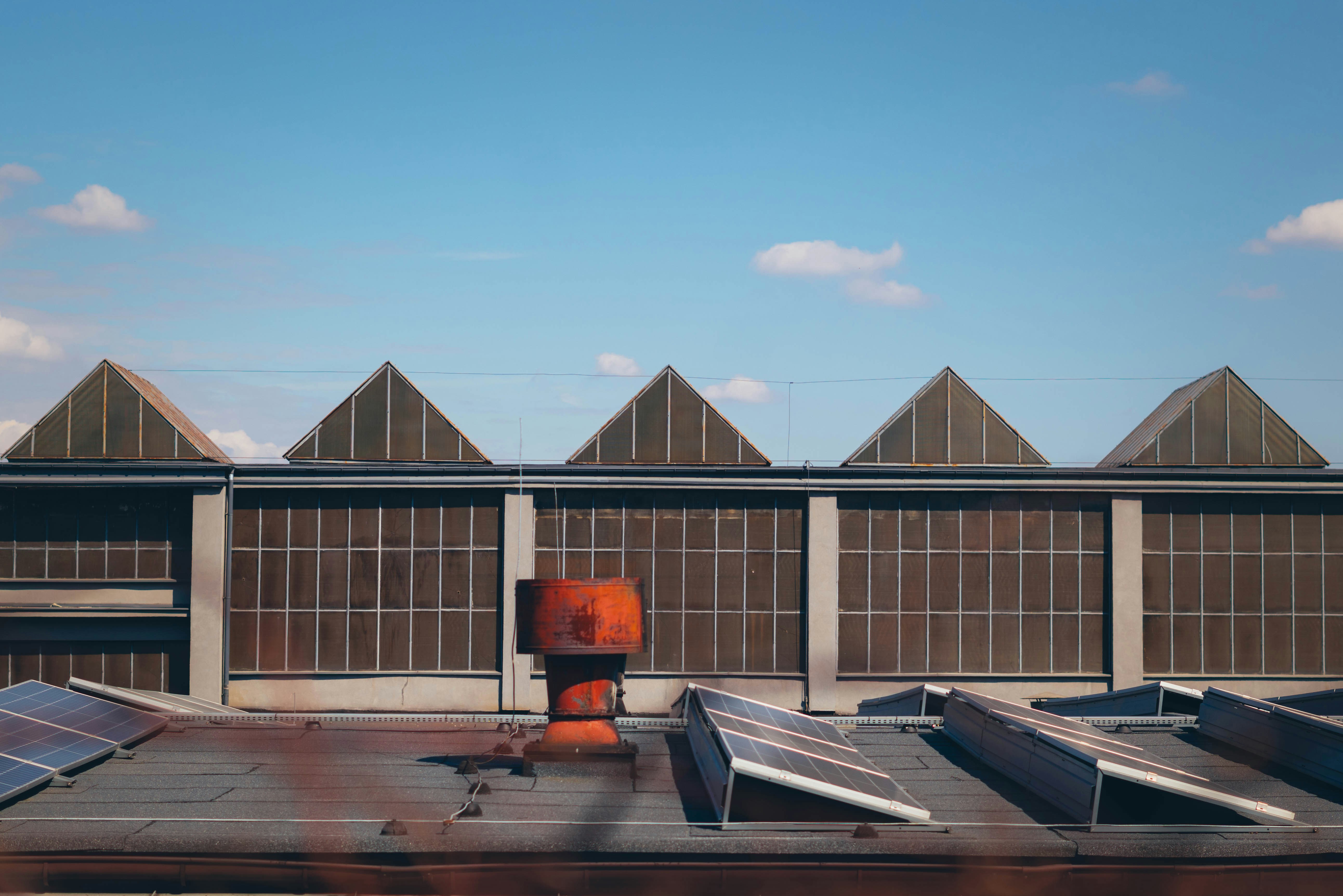 Industrial building with sawtooth roof and sky