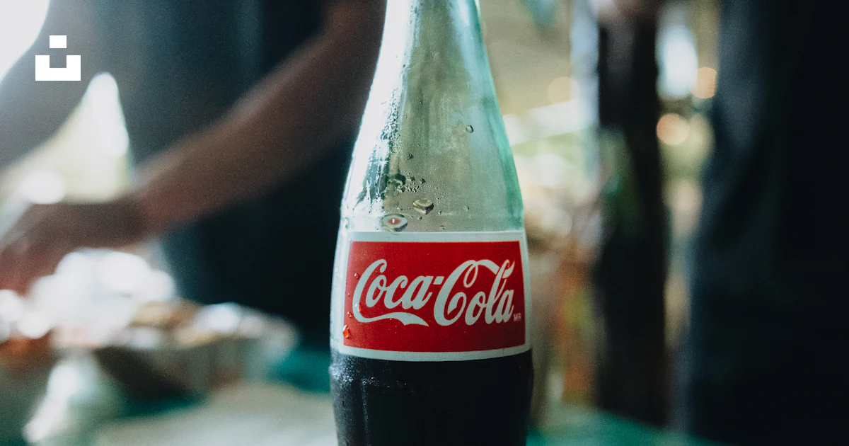Glass bottle of coca-cola on a teal table. photo – Free Table Image on ...