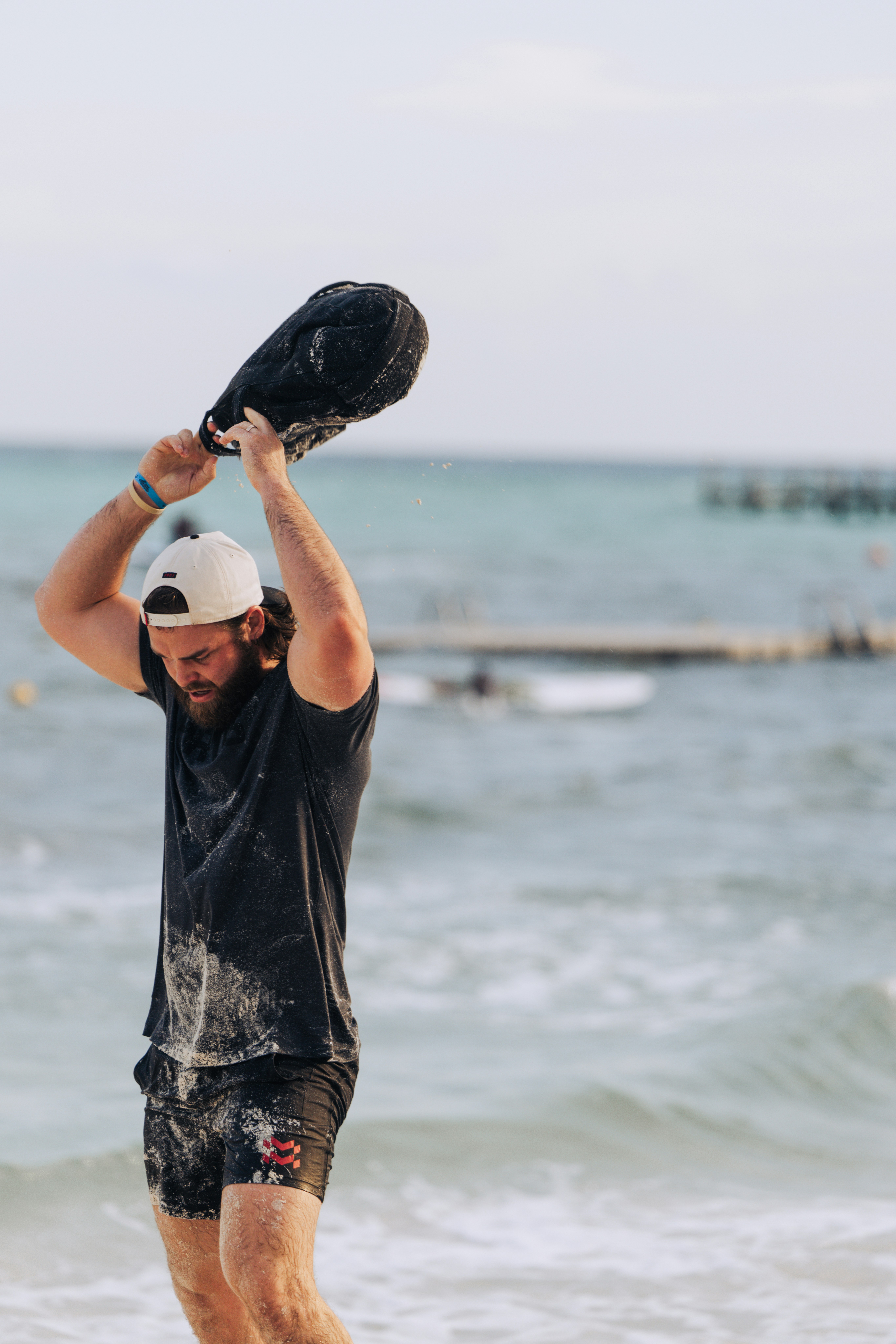 Man lifting weight on the beach