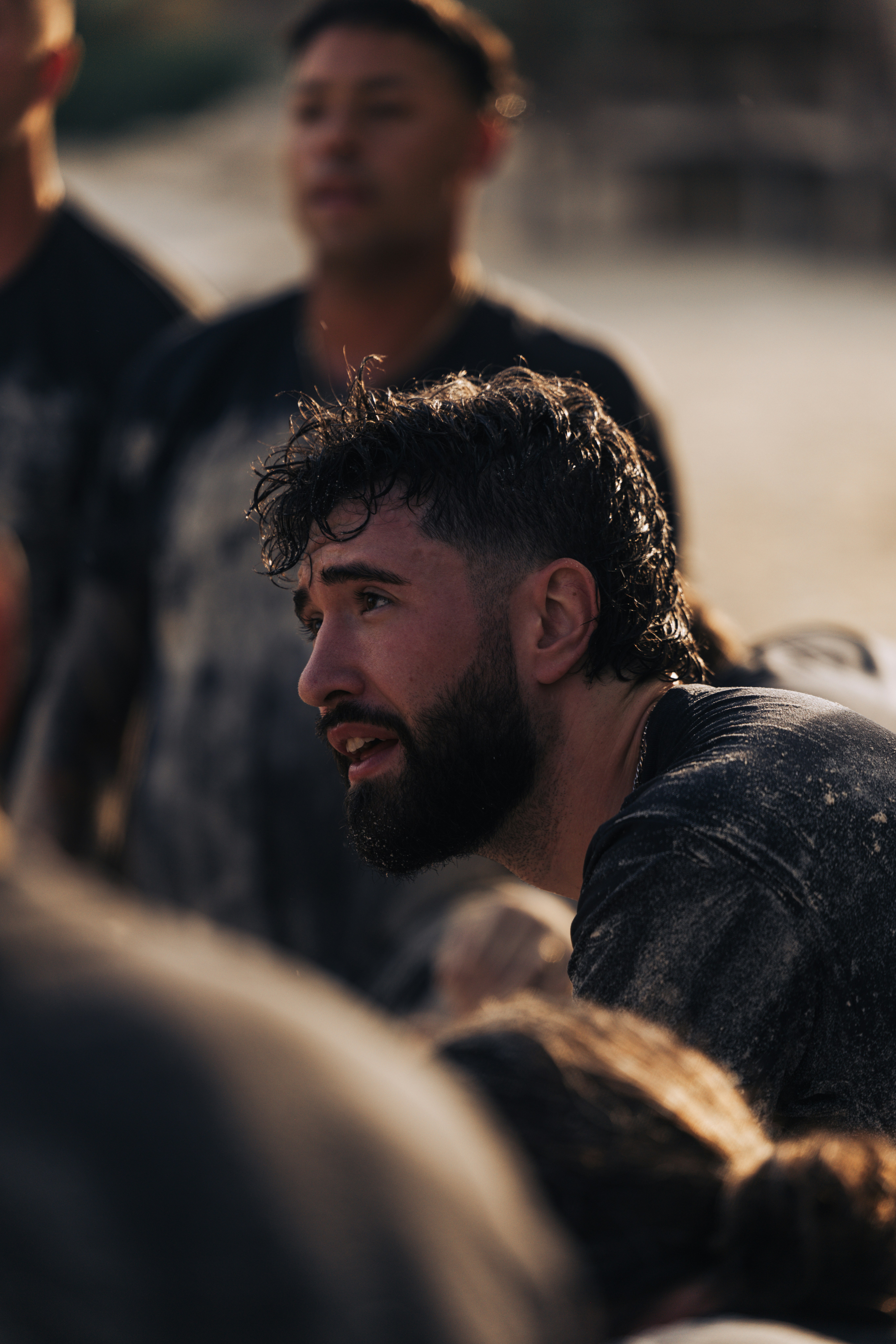 Man with beard and wet hair looking intently