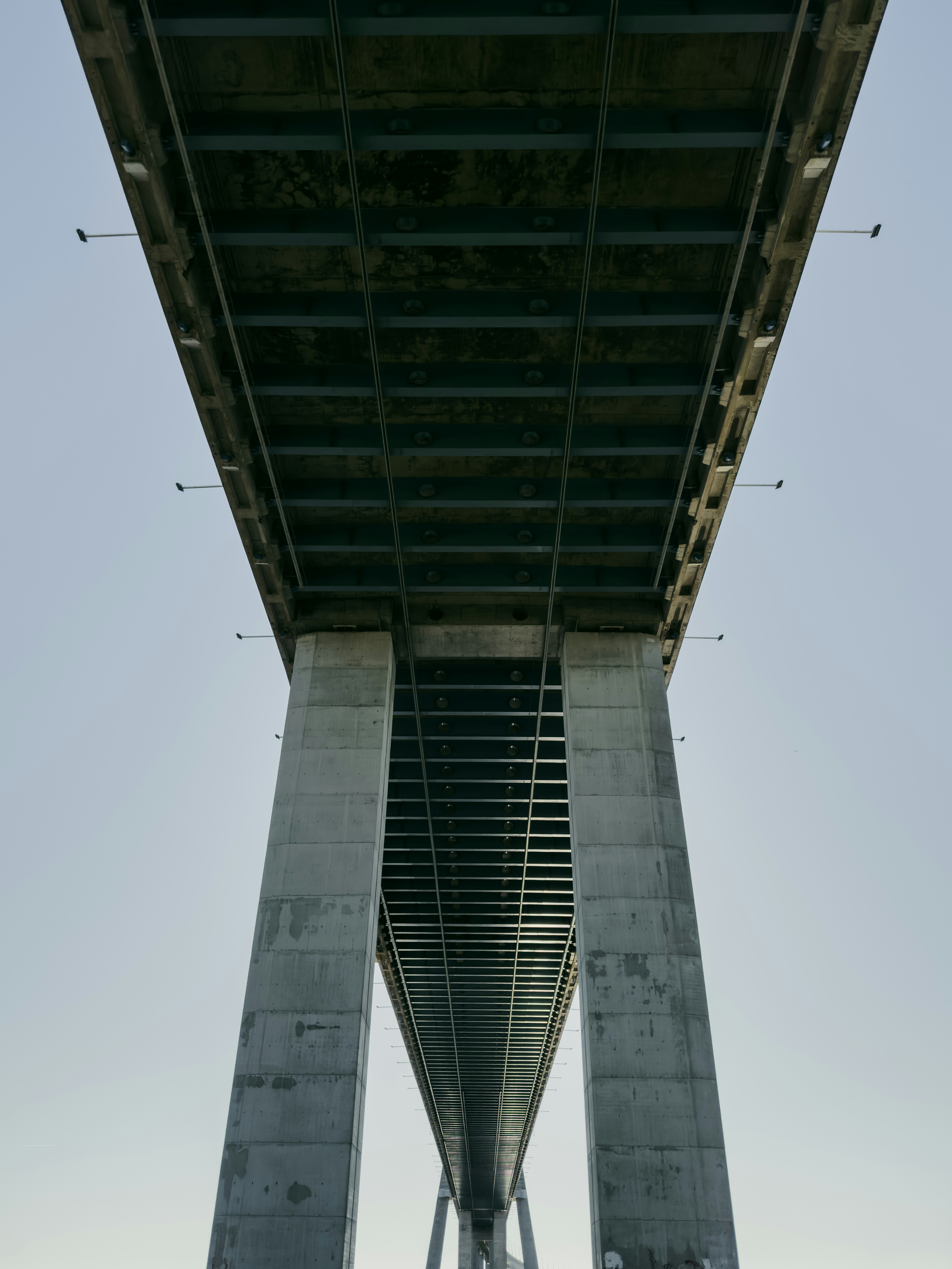 Underside view of a large concrete bridge structure