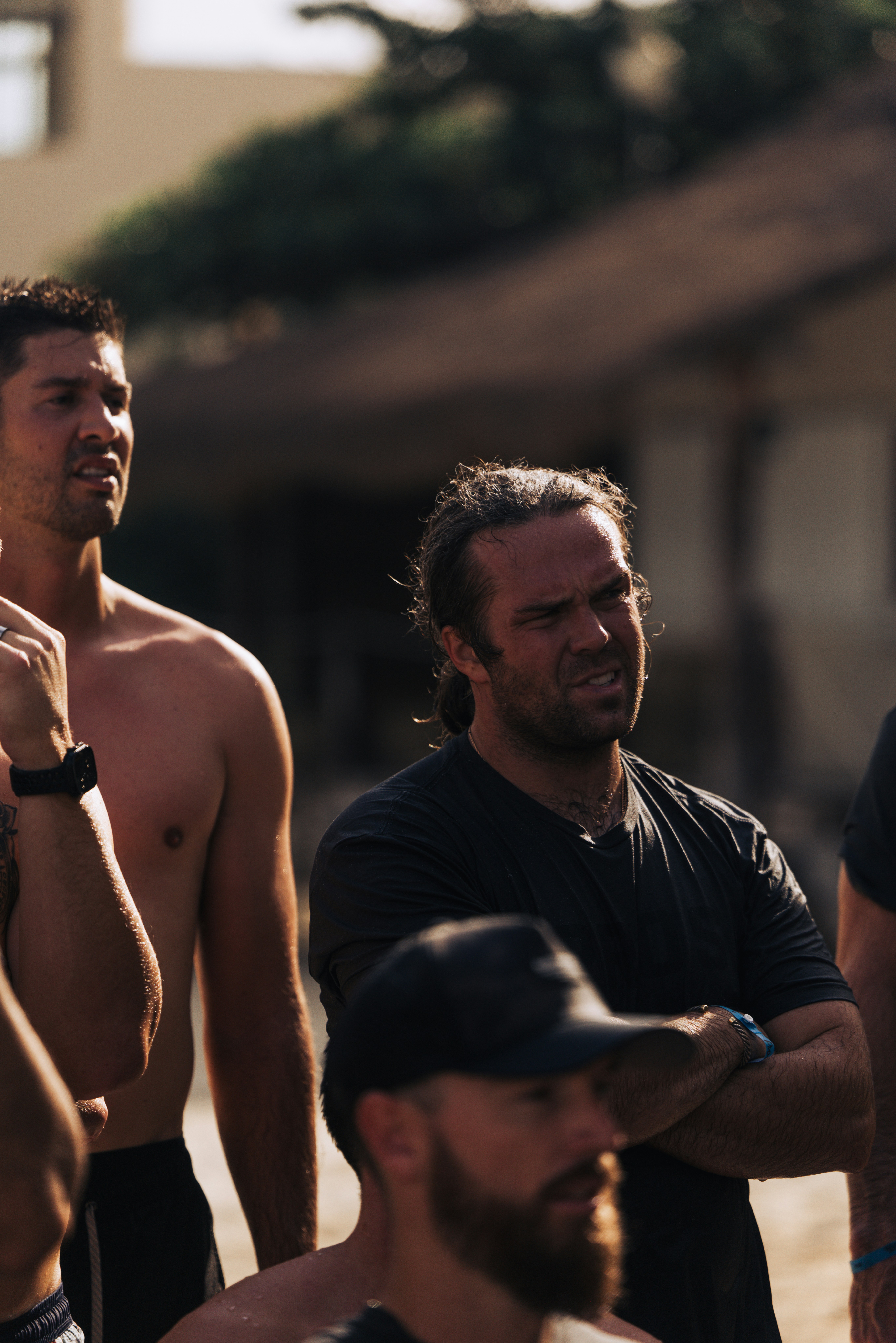 Group of men listening intently outdoors