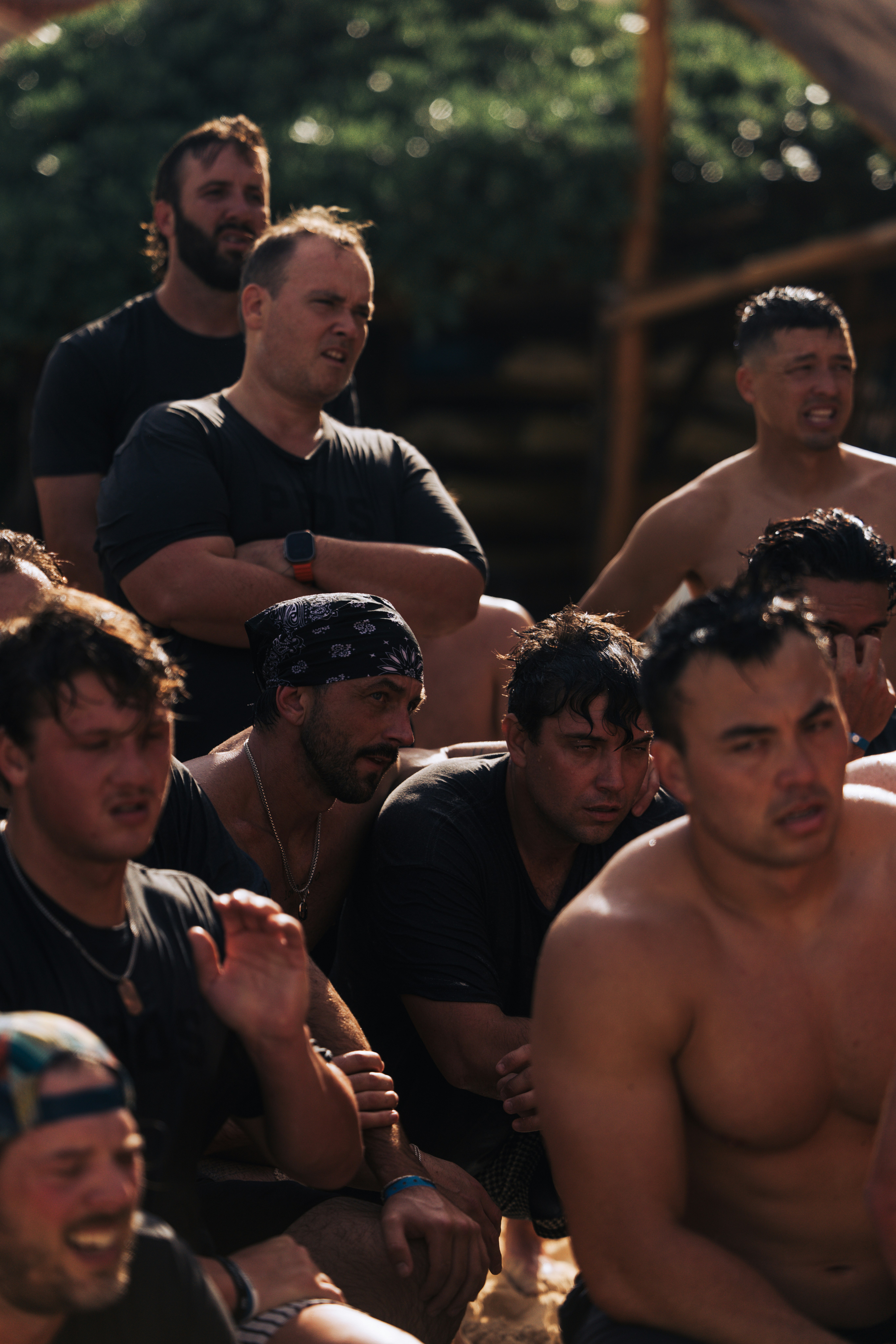 A group of men watching an event outdoors