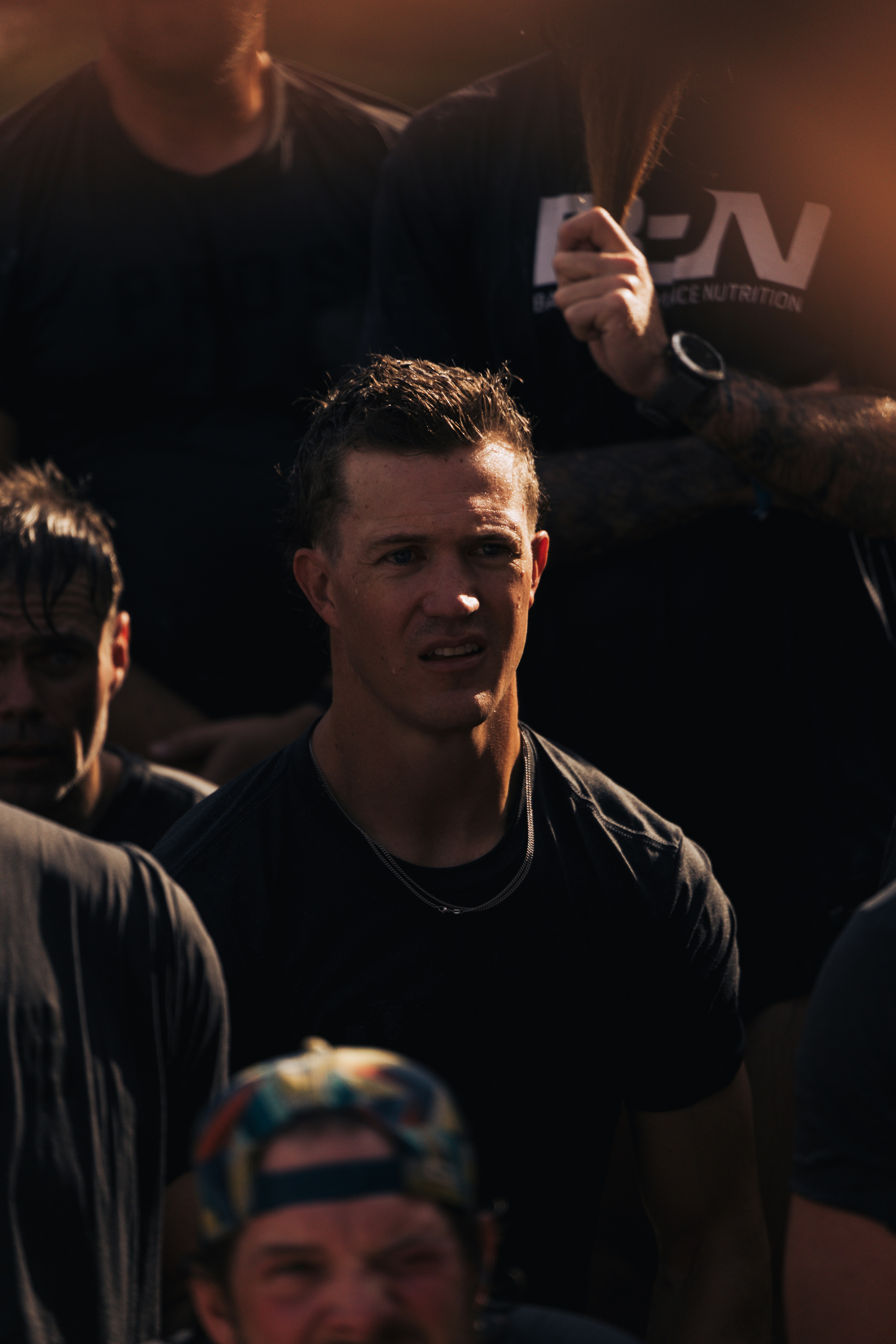 Man in black shirt looking to the side
