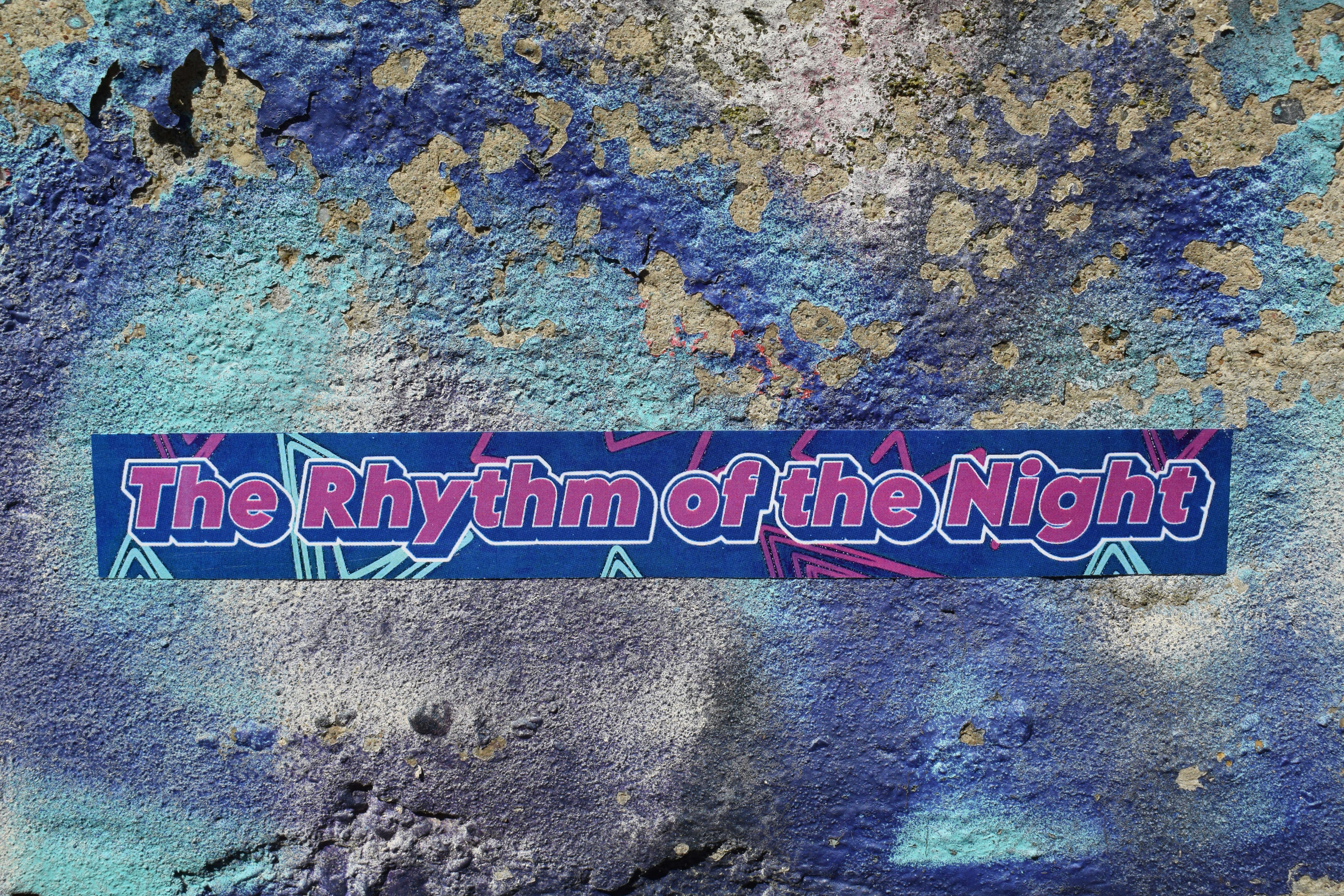 The rhythm of the night text on wall