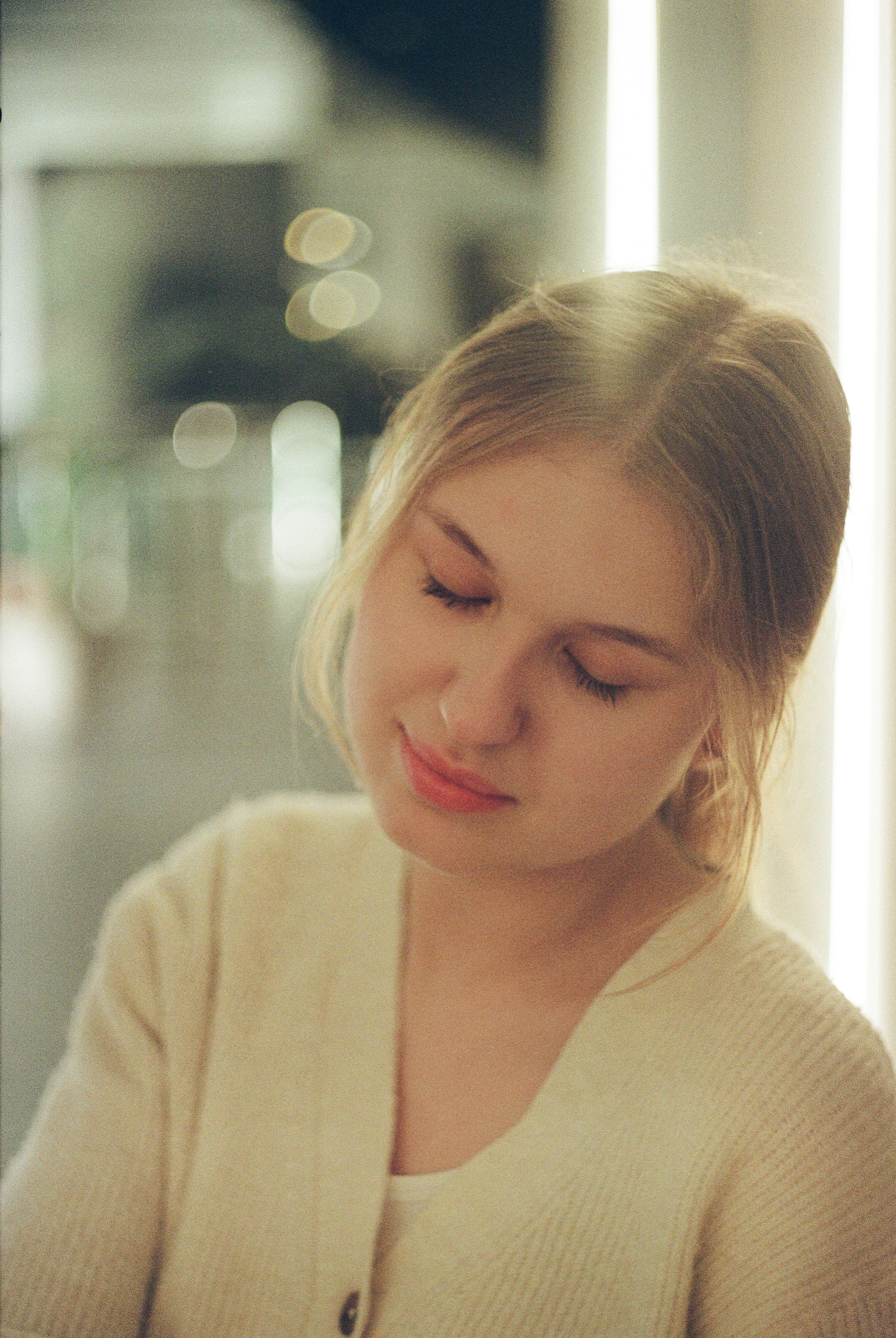 Young woman with eyes closed and a gentle smile.