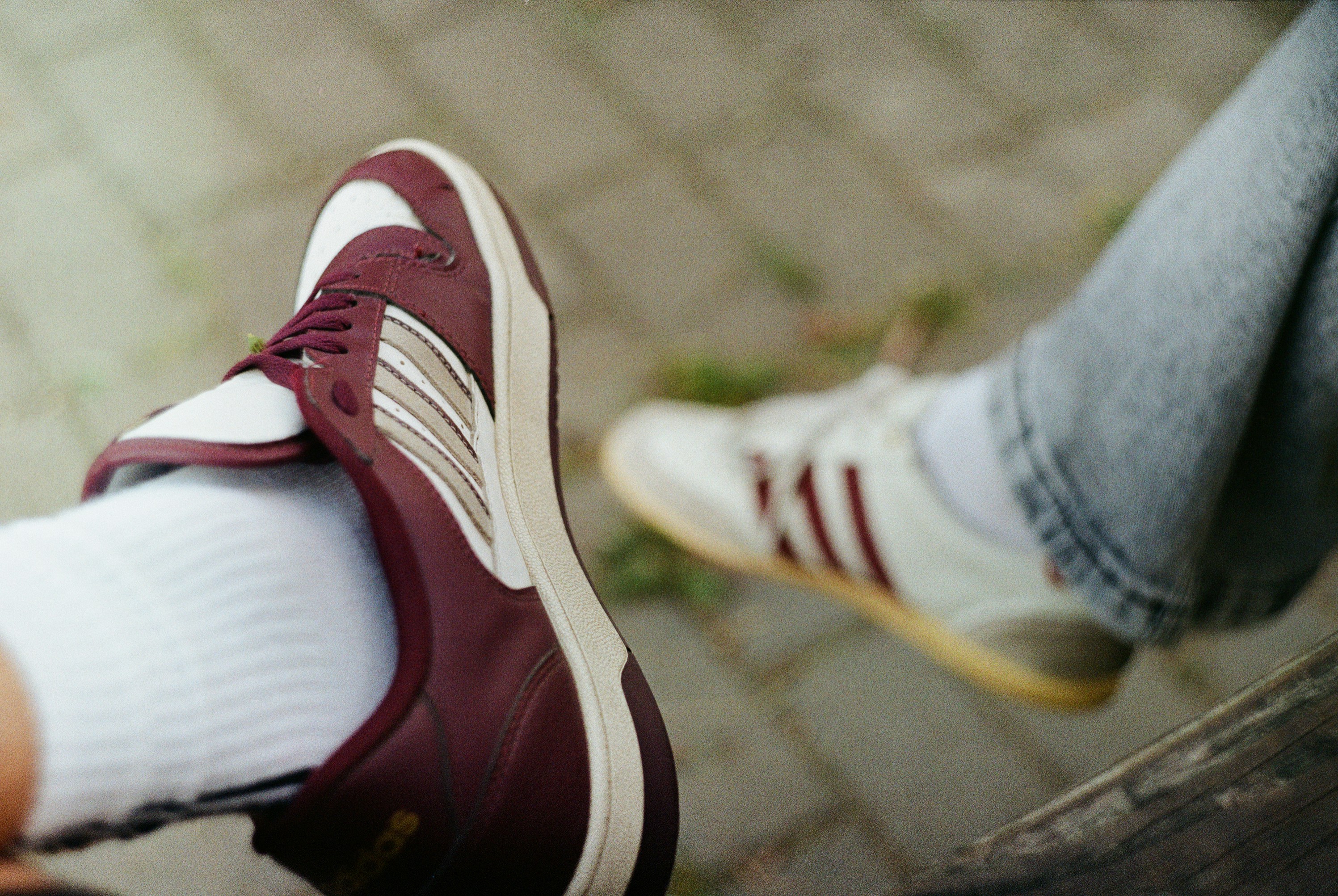 Two pairs of athletic shoes on pavement