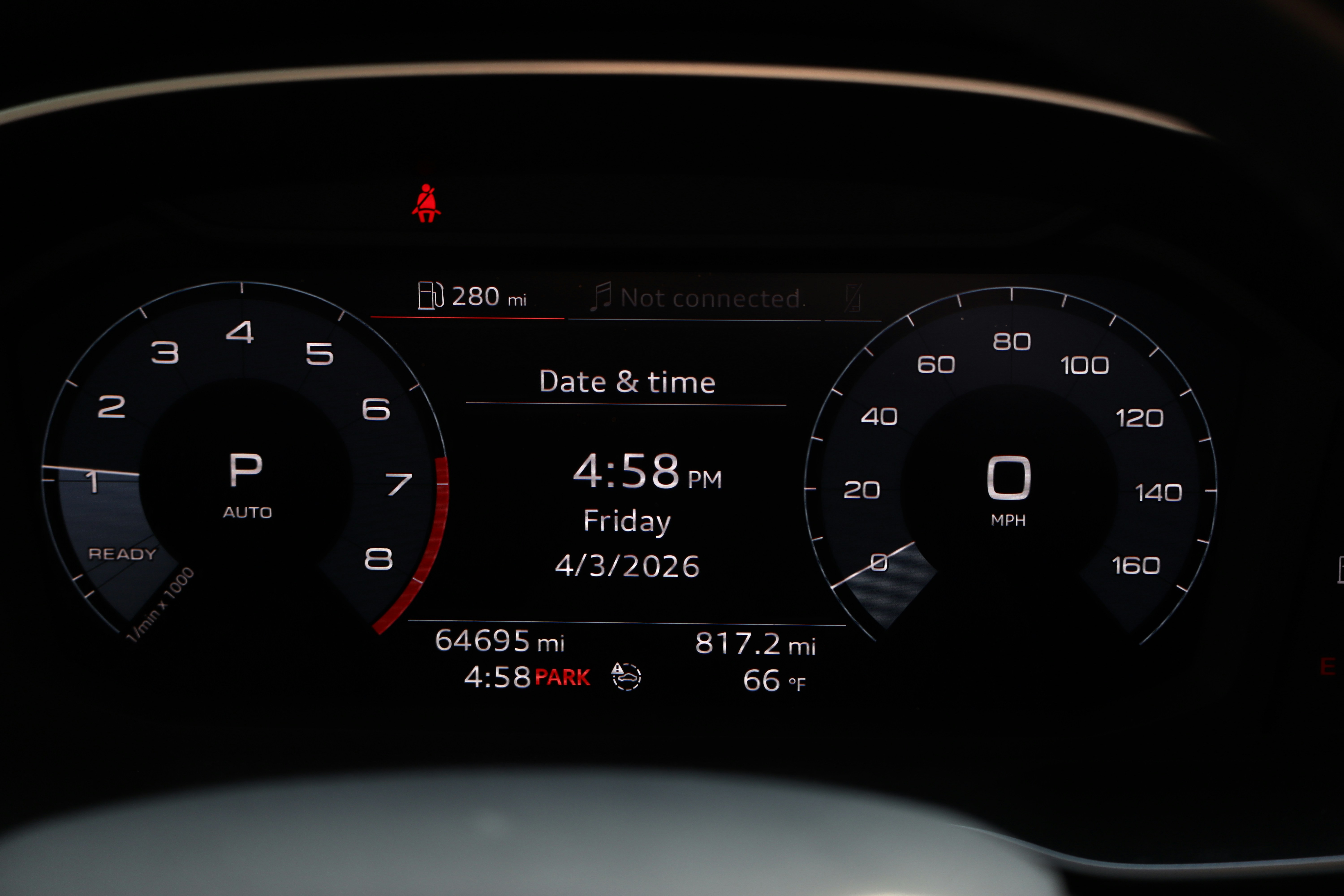 Car dashboard showing speed, date, and time