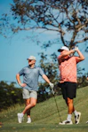 Two men playing golf on a sunny day