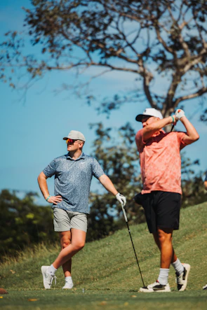 Two men playing golf on a sunny day