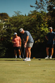 Men playing golf on a sunny day