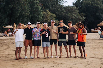 Group of friends posing on a sandy beach