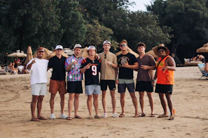 Group of friends posing on a sandy beach