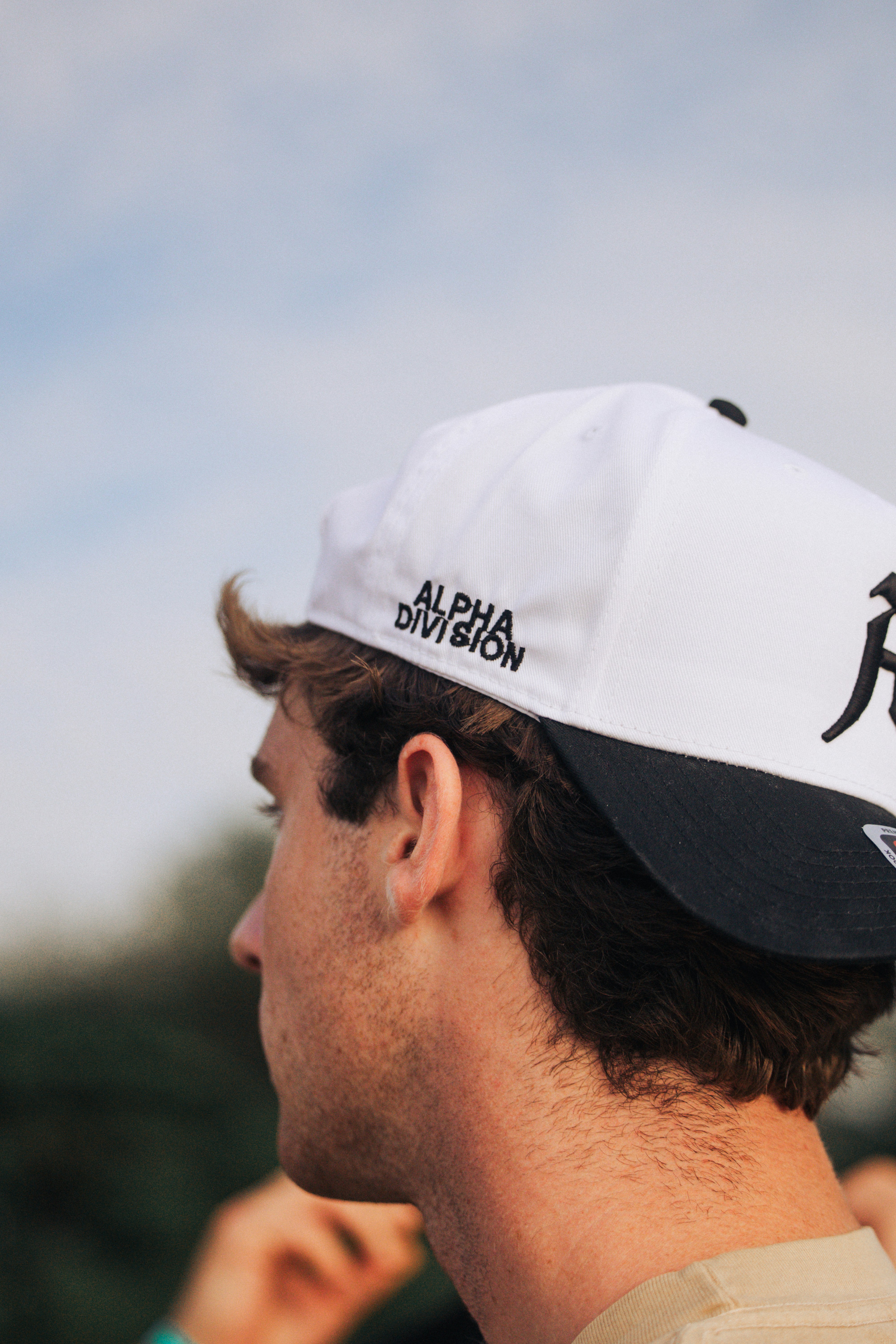 Man wearing a white and black baseball cap