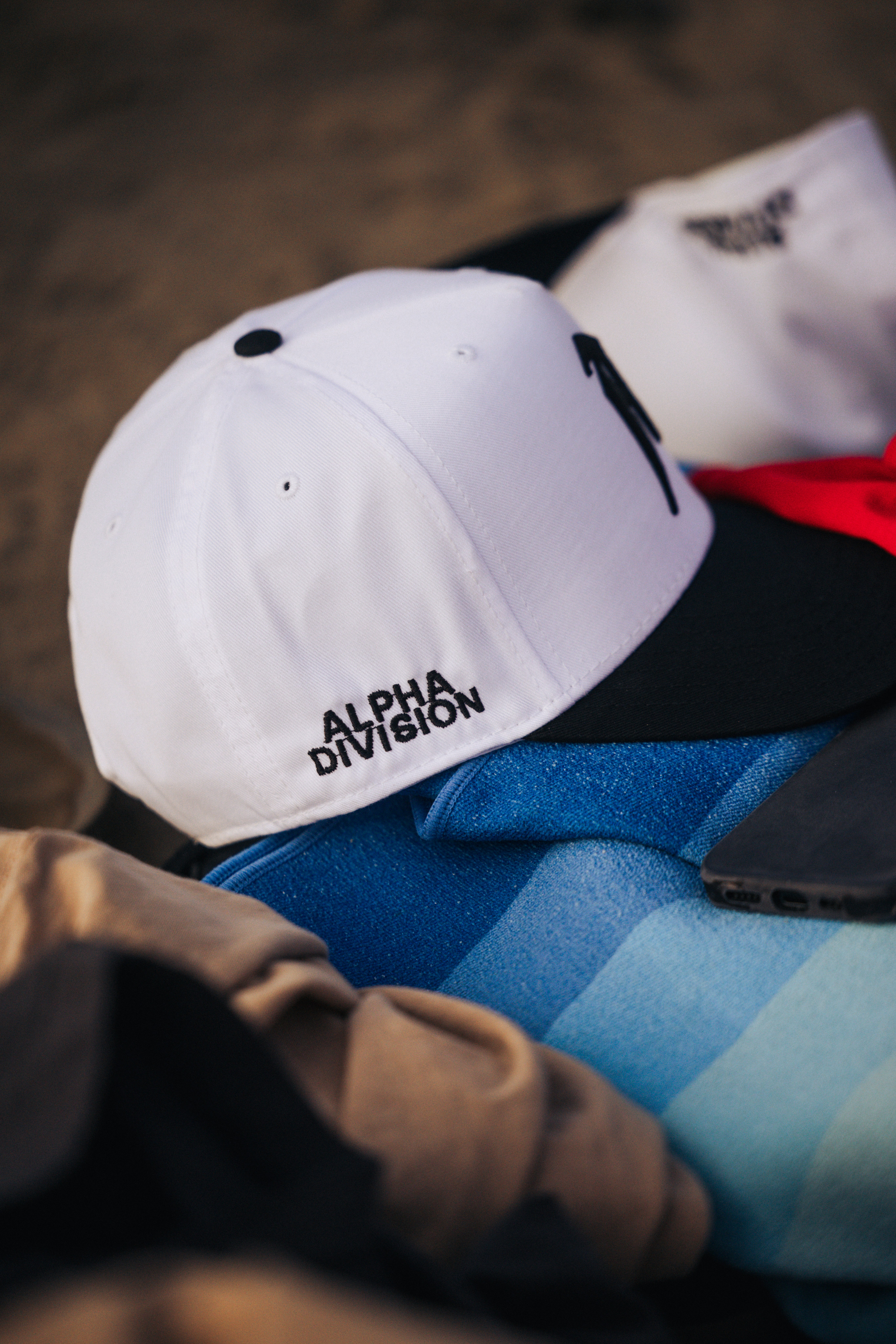 A white baseball cap with black brim and logo.