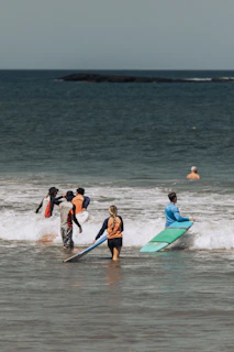 People learning to surf in the ocean