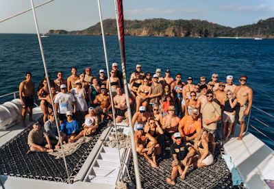 Large group of people on a boat with ocean background