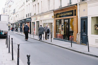 People walking down a parisian street with shops