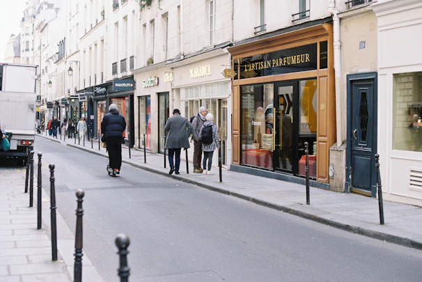 People walking down a parisian street with shops