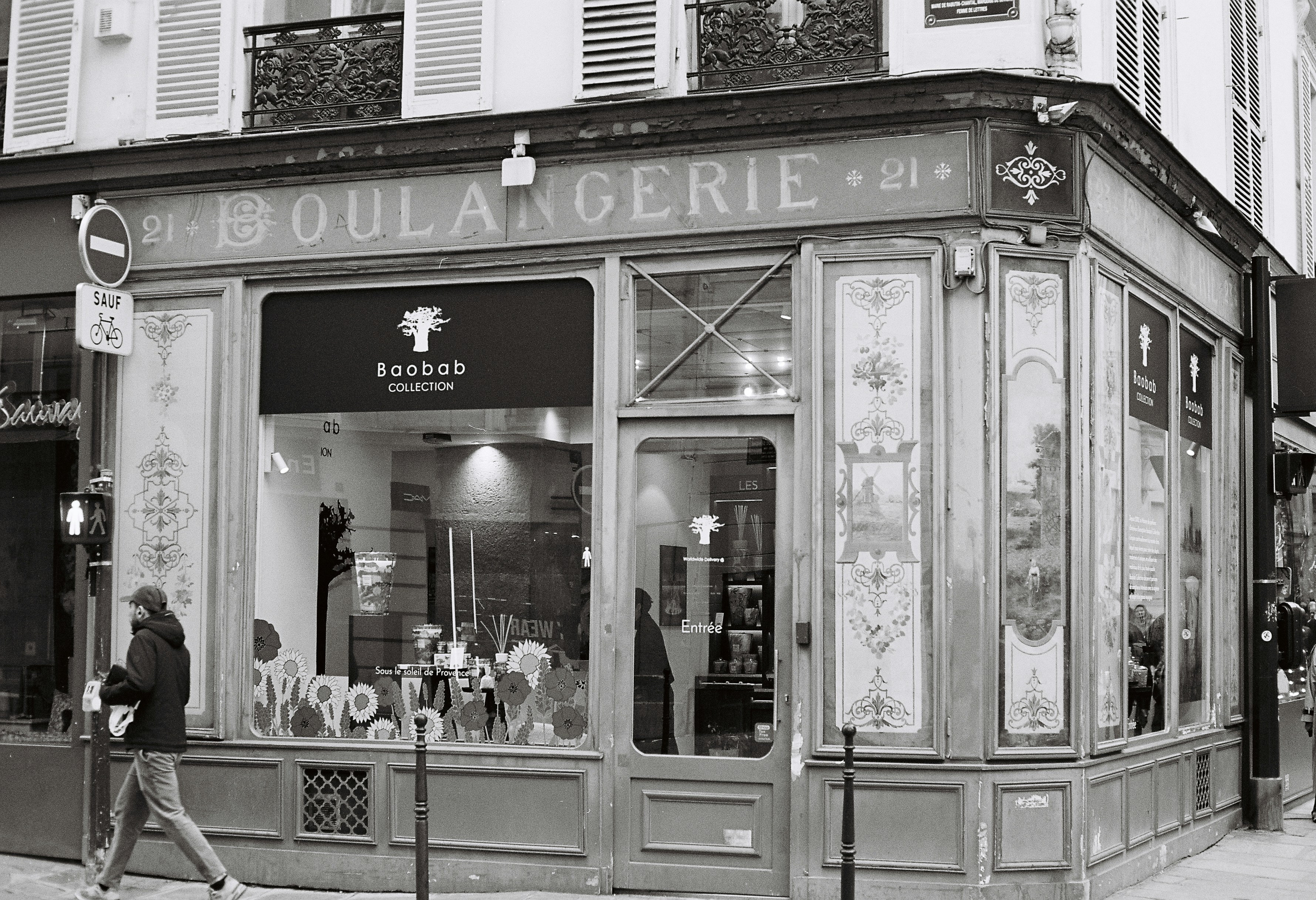 Boulangerie storefront with a person walking by.