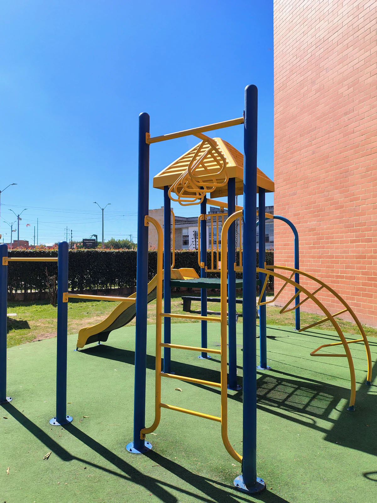 A colorful playground with blue and yellow equipment