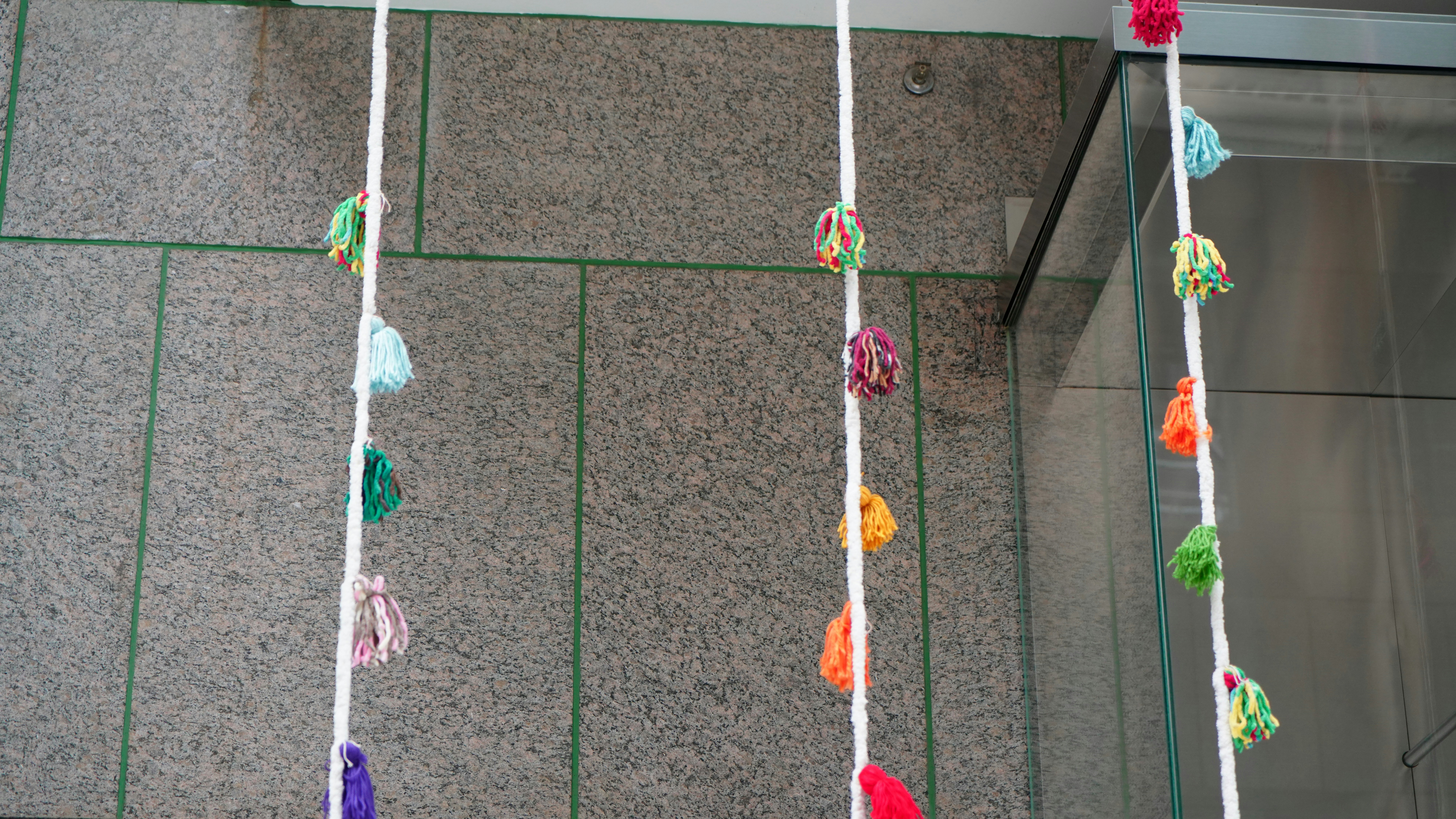 Colorful tassels hanging on white strings