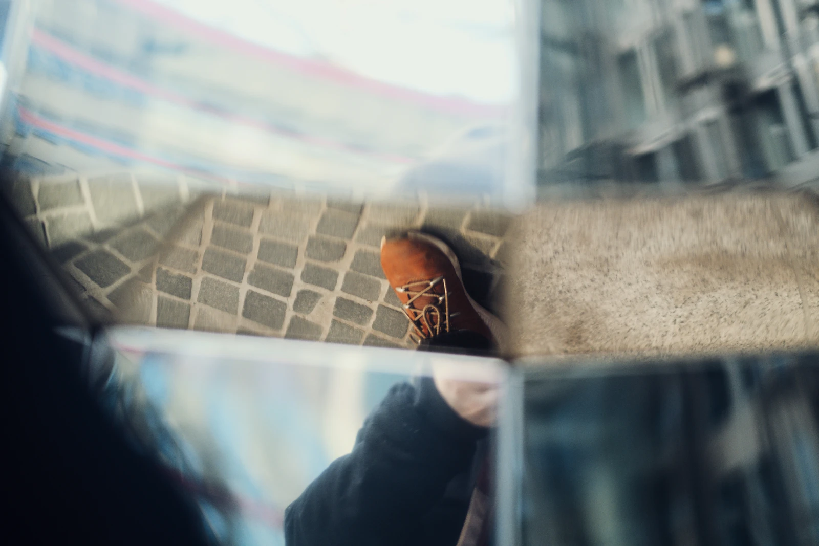 Close-up of a leather boot on a paved city street