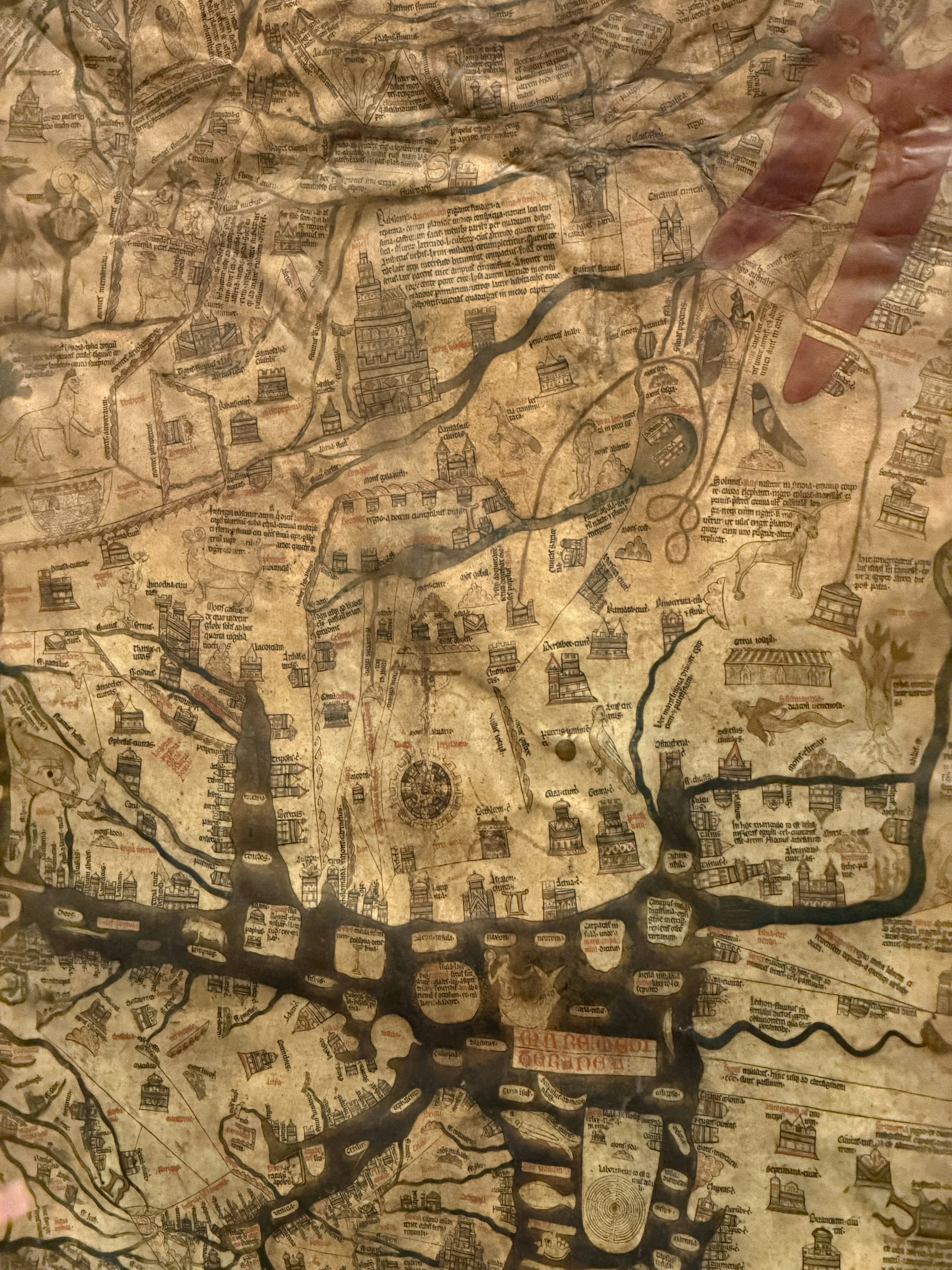 Ancient parchment map with intricate details and text.