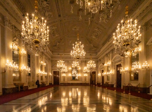 Grand ballroom with ornate chandeliers and polished floor