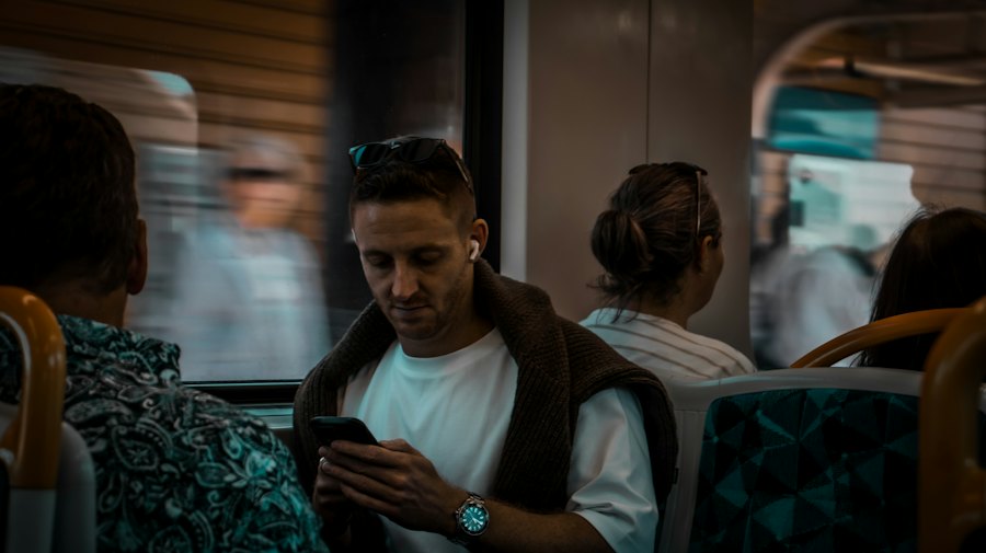 Commuter checking their phone while travelling on public transport