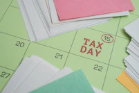 Tax day marked on a calendar with papers