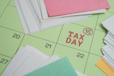 Tax day marked on a calendar with papers.