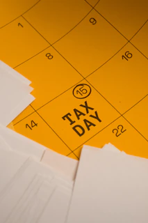 Calendar marked with tax day and circled date 15th circled