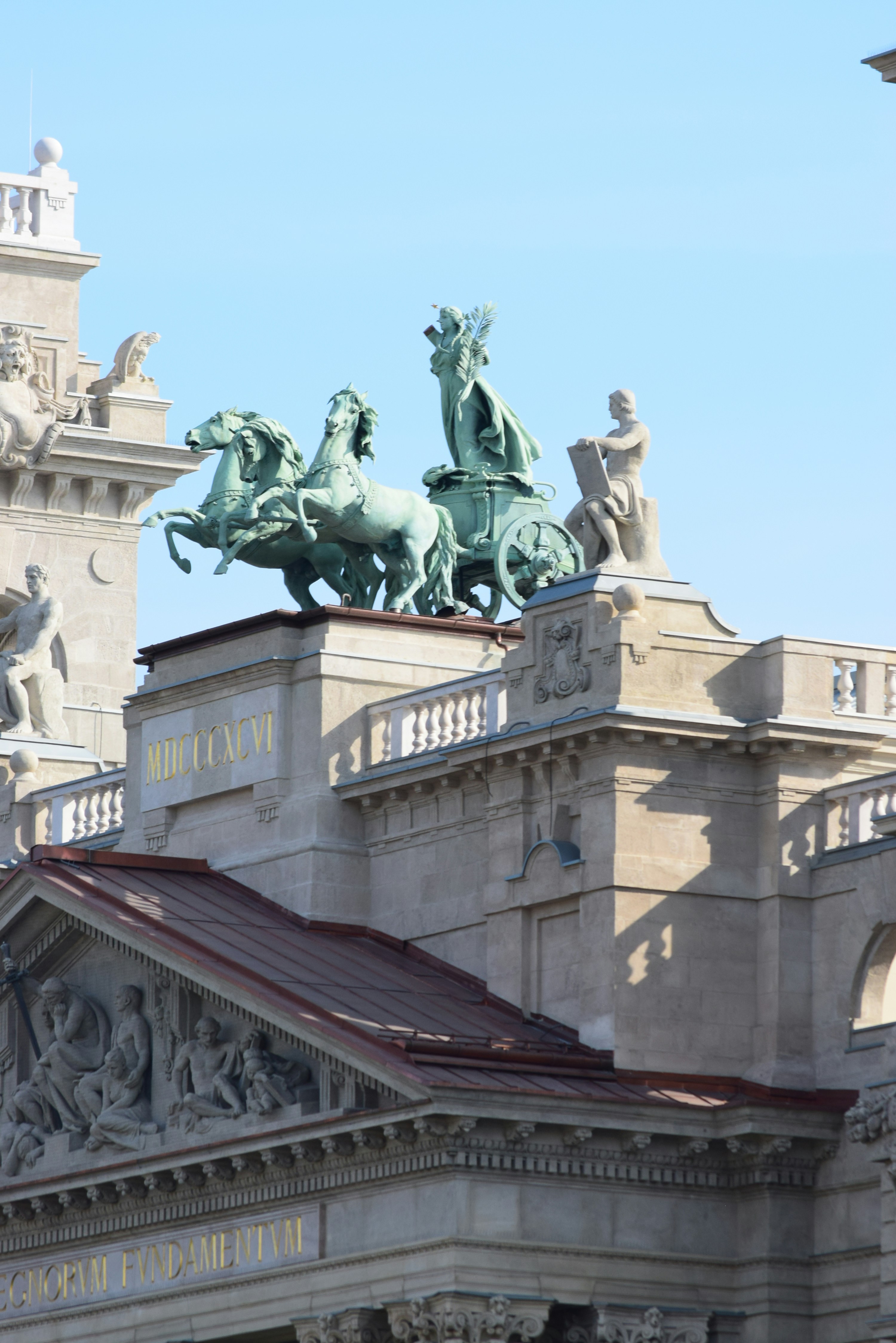 Bronze chariot sculpture atop a grand building