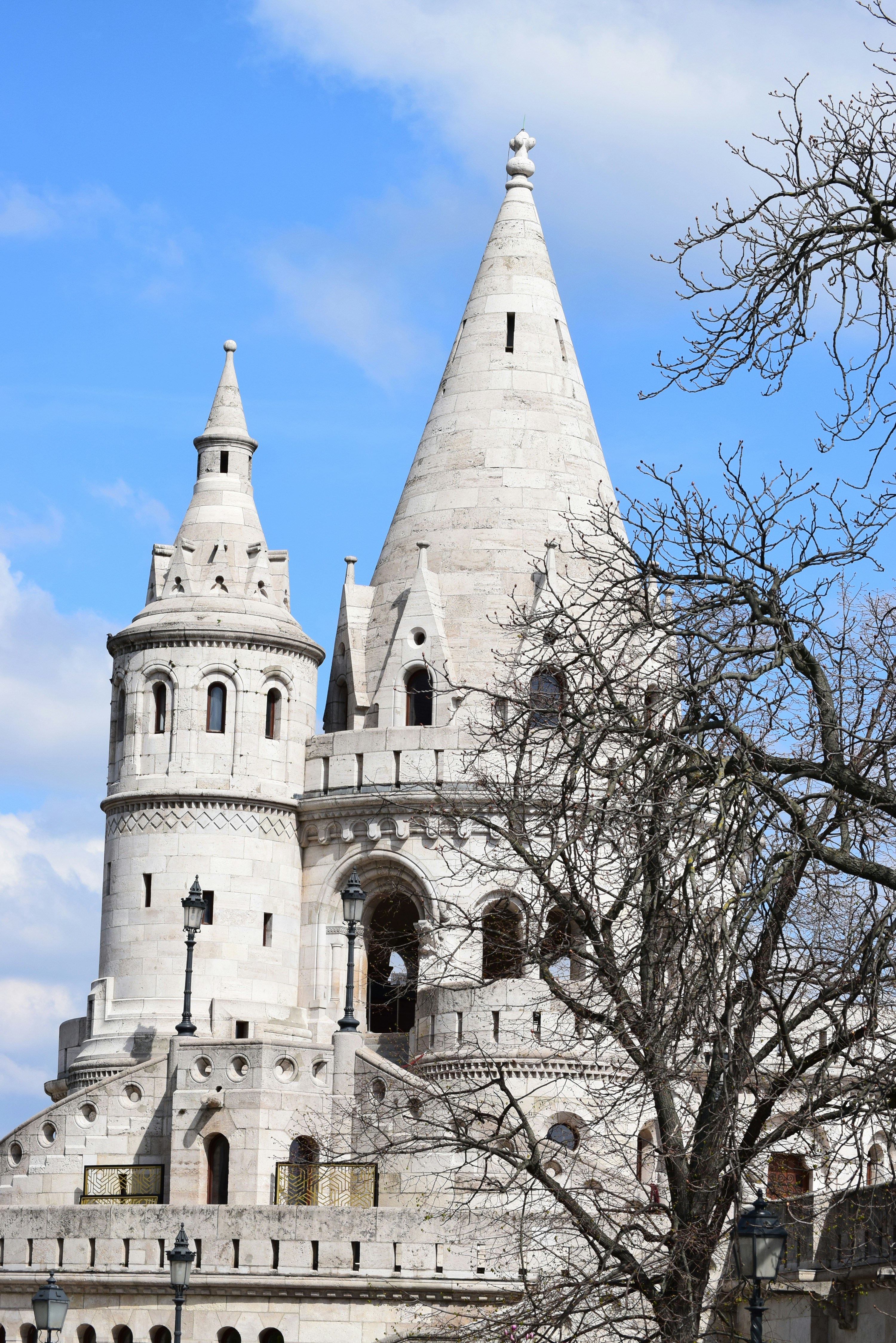 White stone castle towers against blue sky