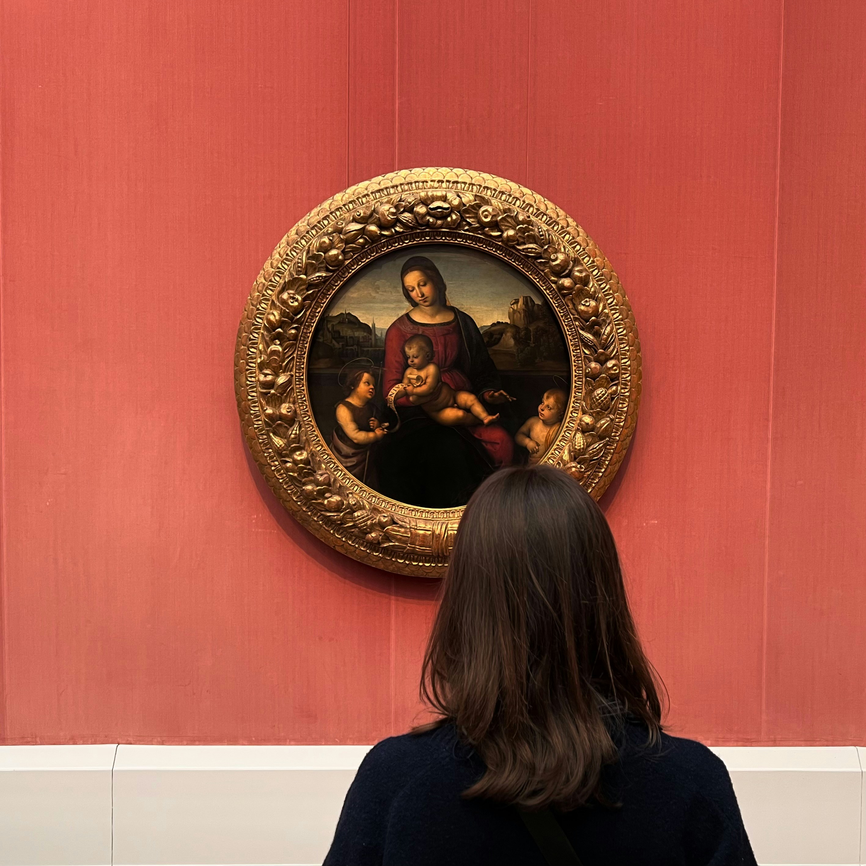 Woman looking at a painting in a museum