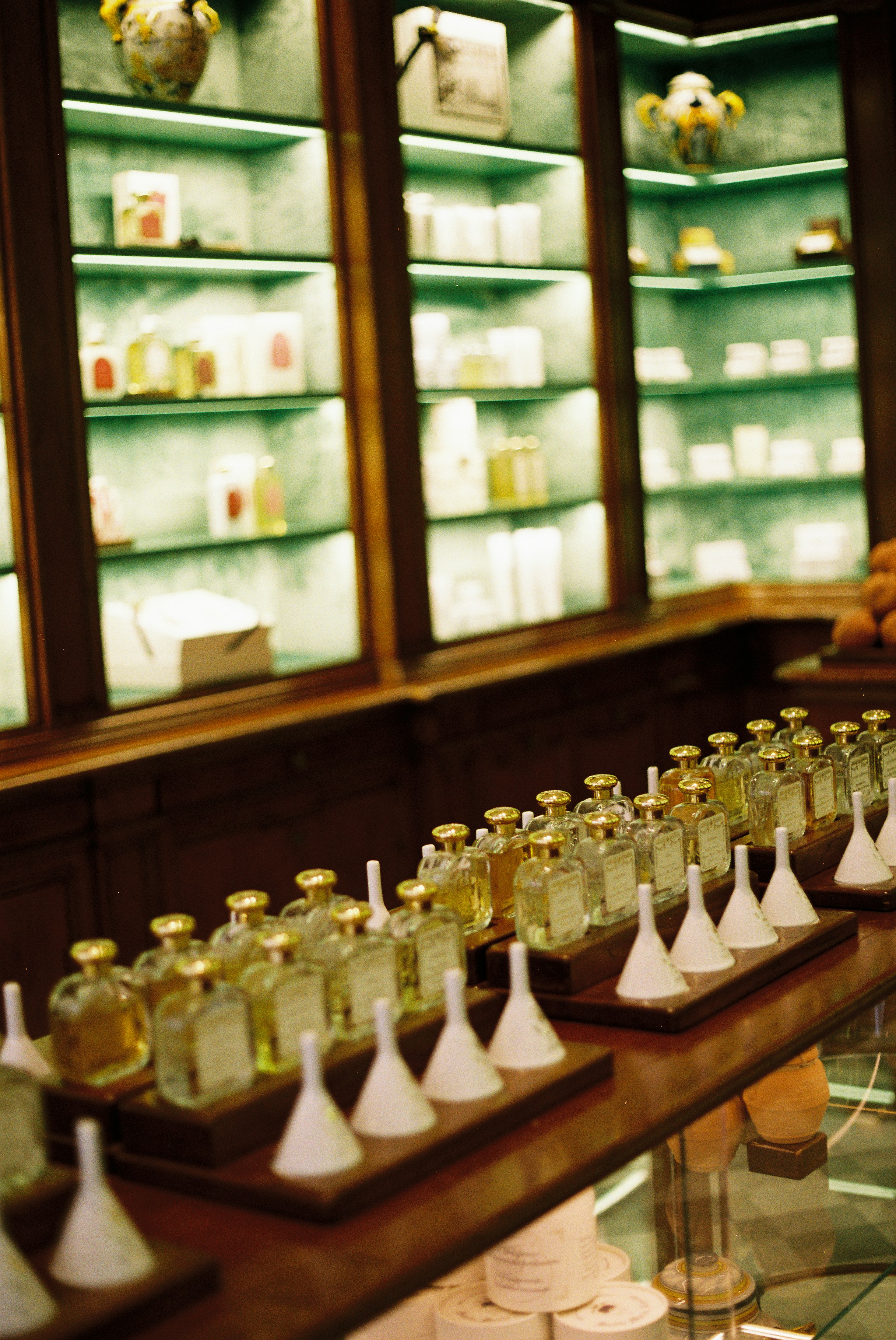 Perfume bottles displayed on shelves in a shop.