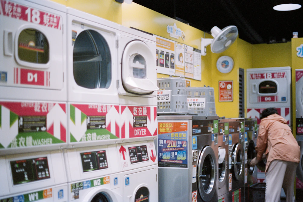 A customer using washing machines inside a laundromat