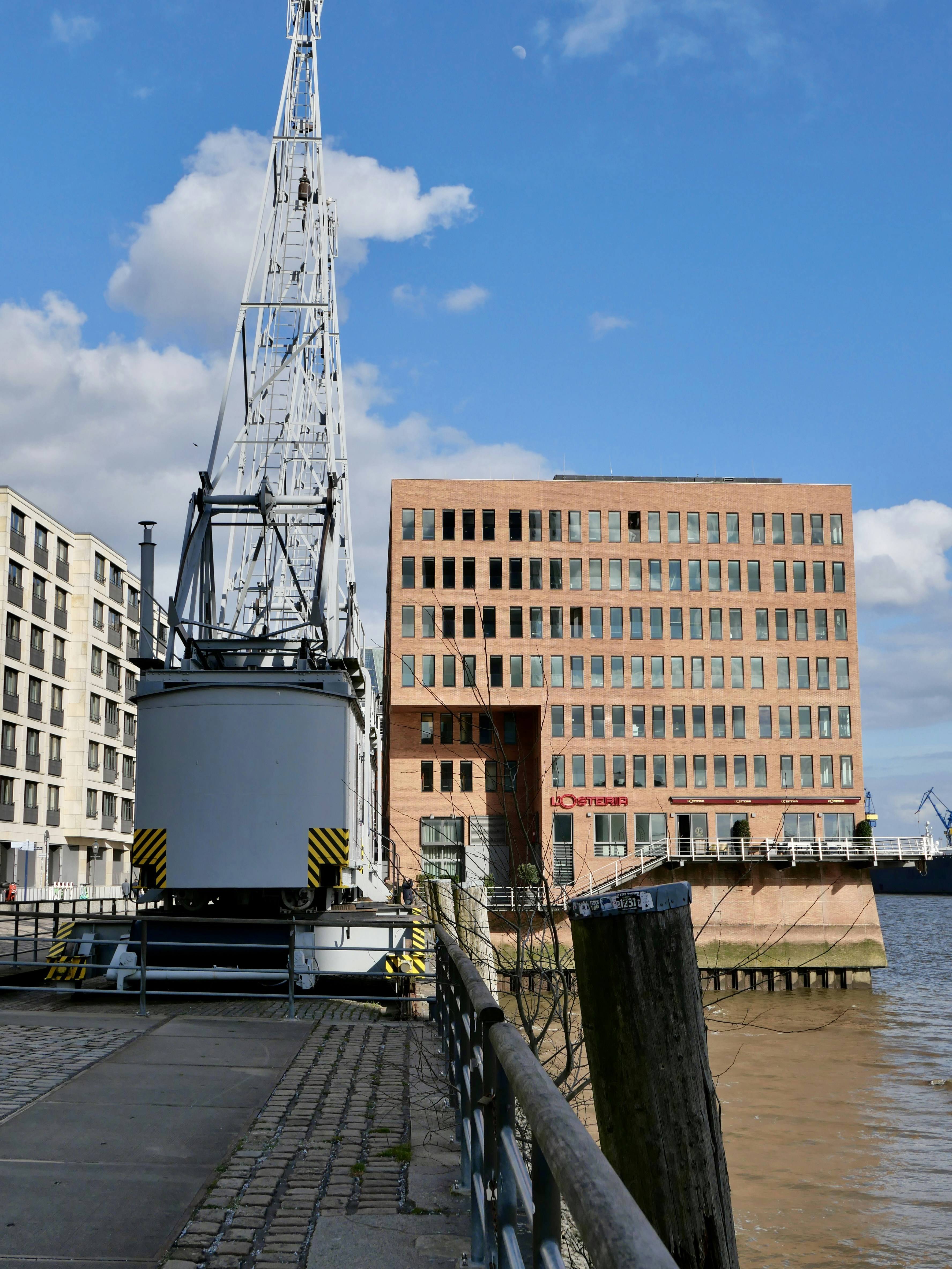 Large crane and brick building by the water