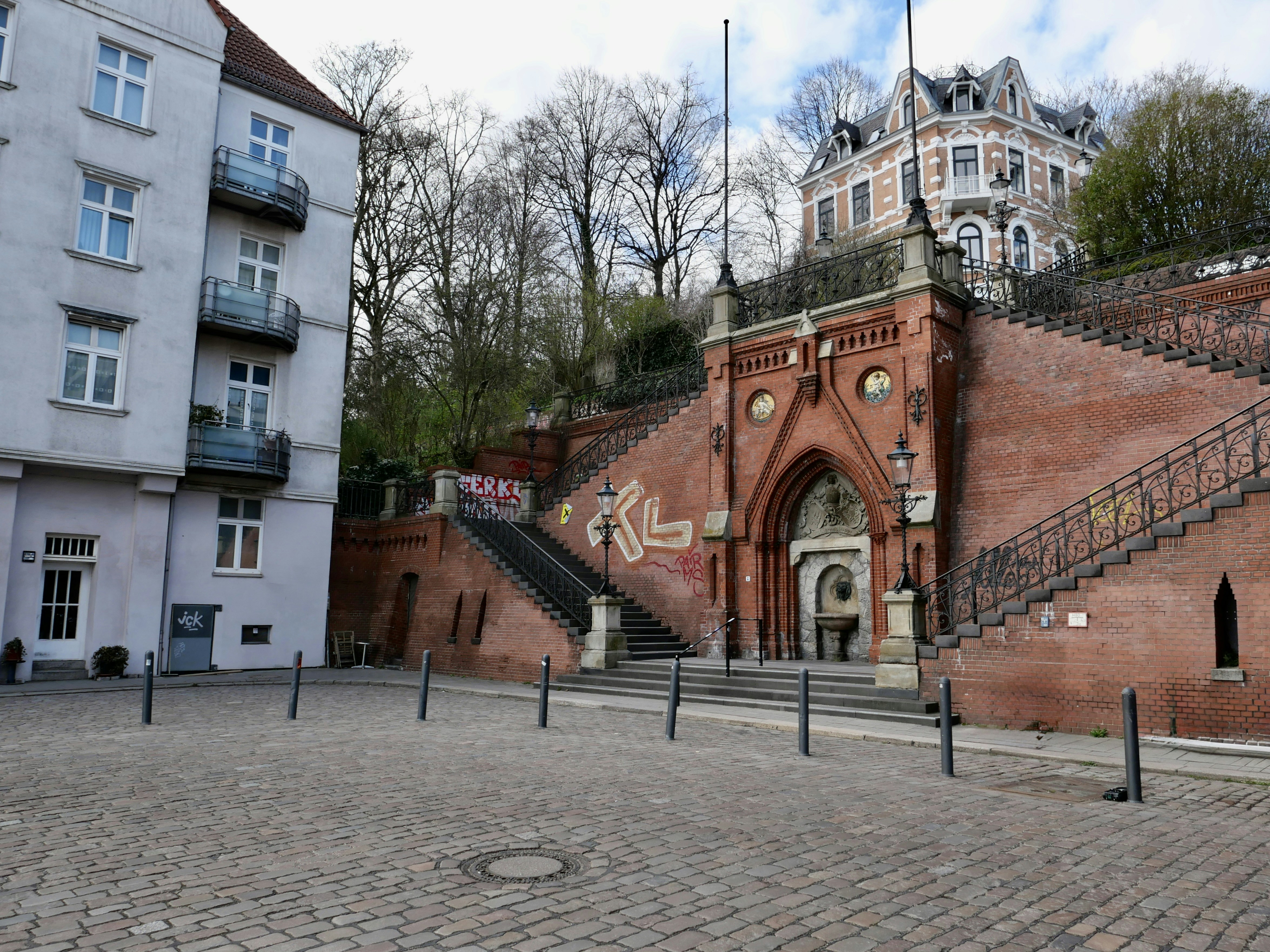 Ornate brick staircase leads up to a grand building