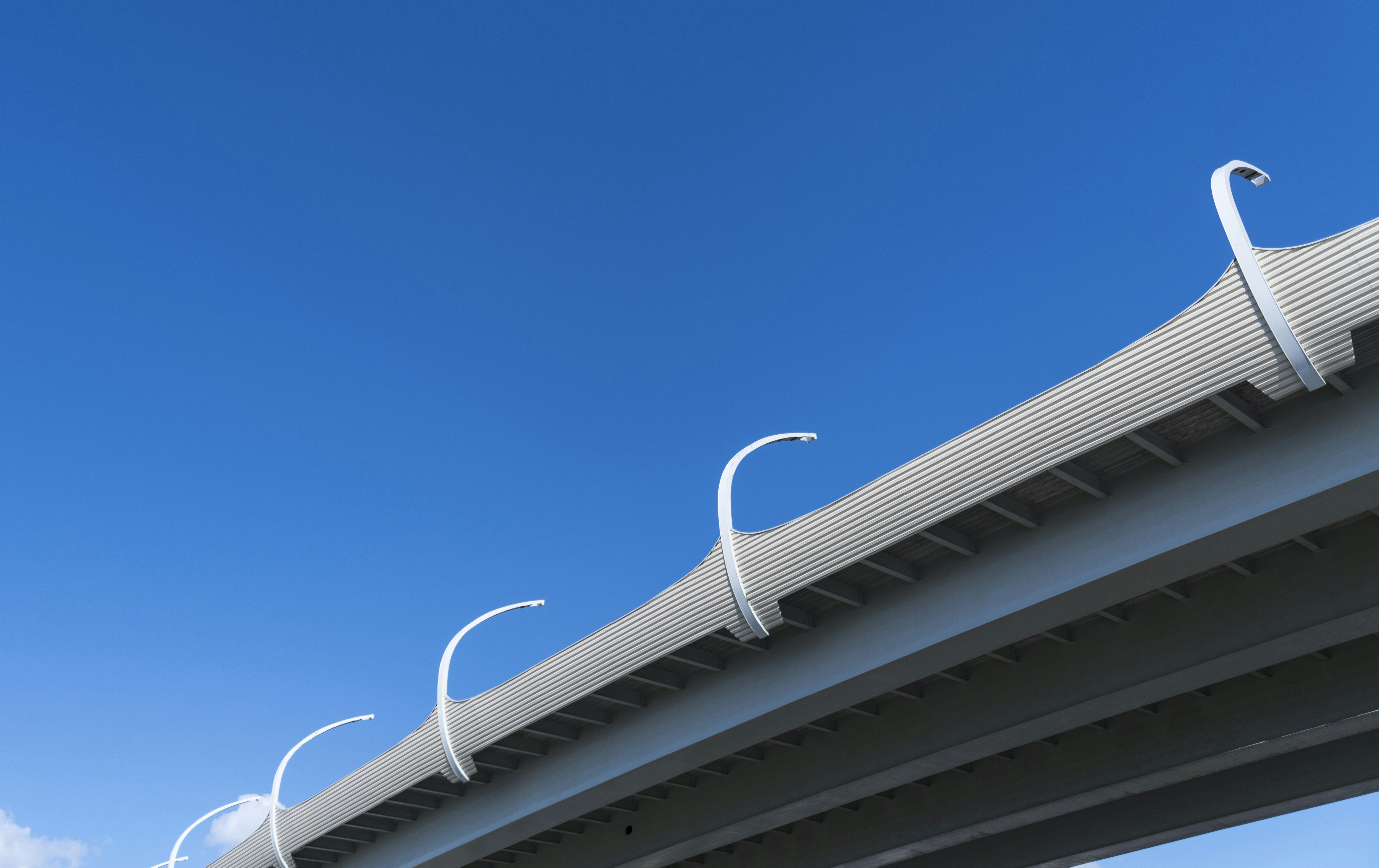 Modern bridge structure against a clear blue sky