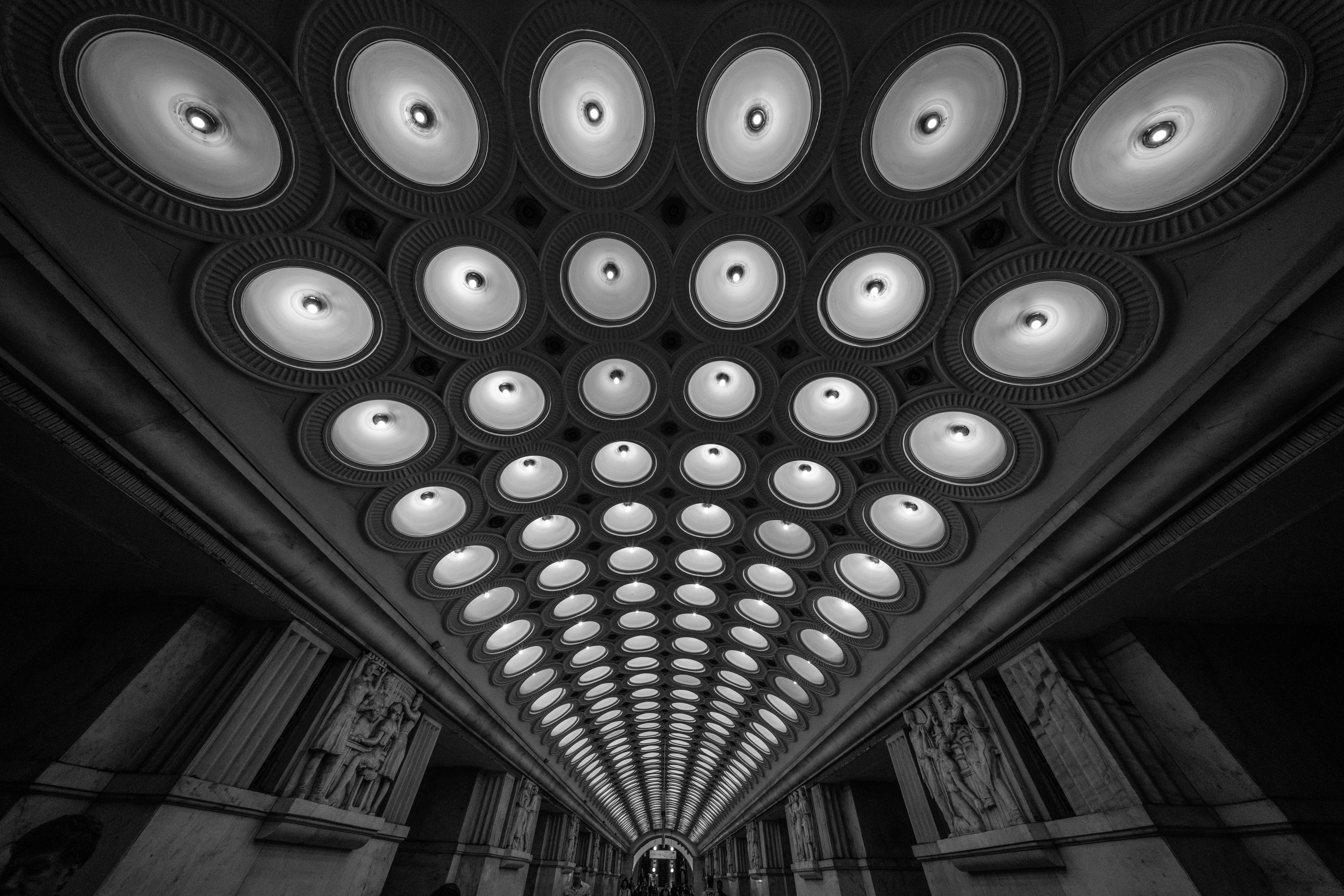 Symmetrical ceiling with many lights receding into distance