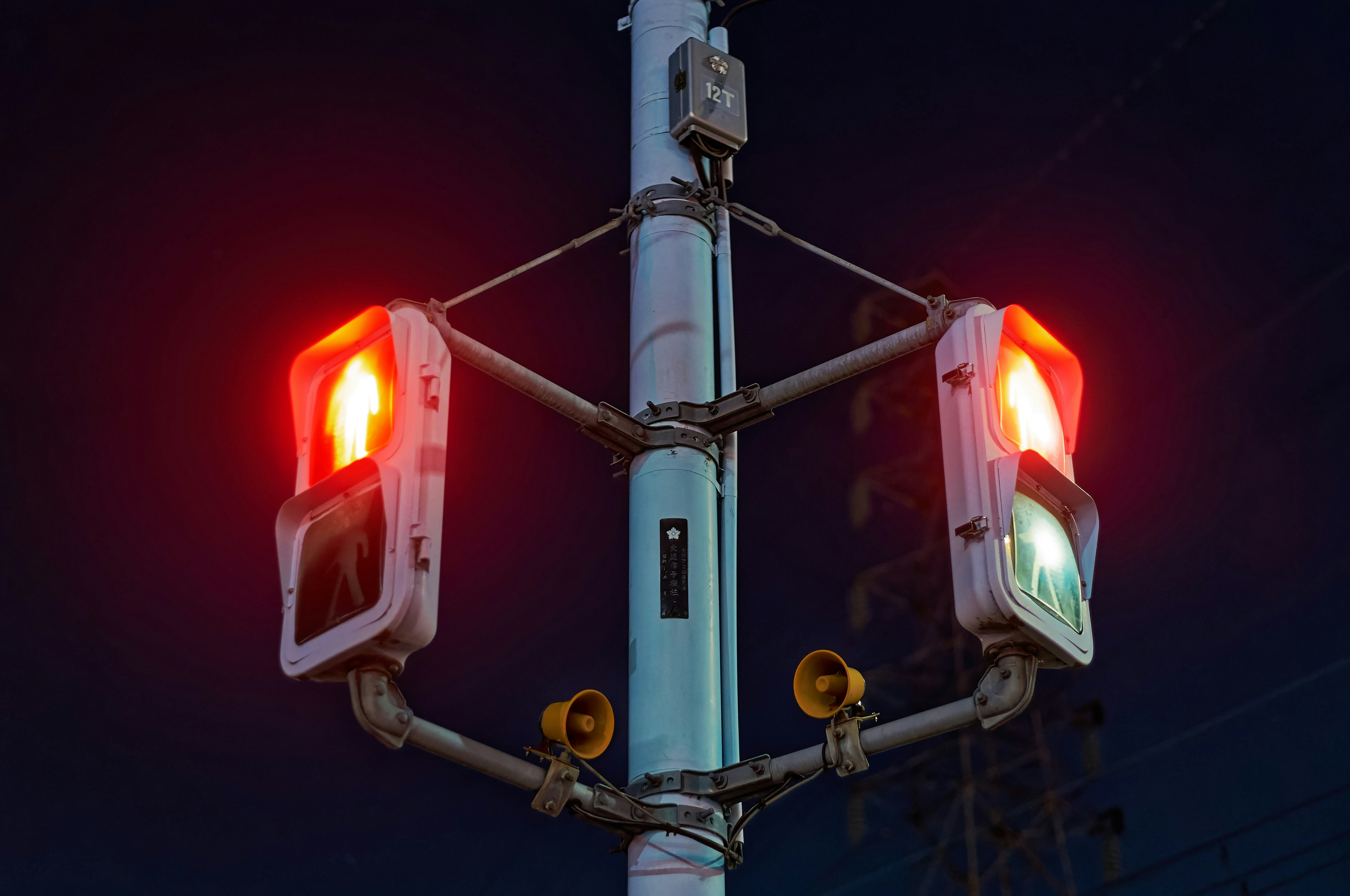Two red traffic lights on a pole